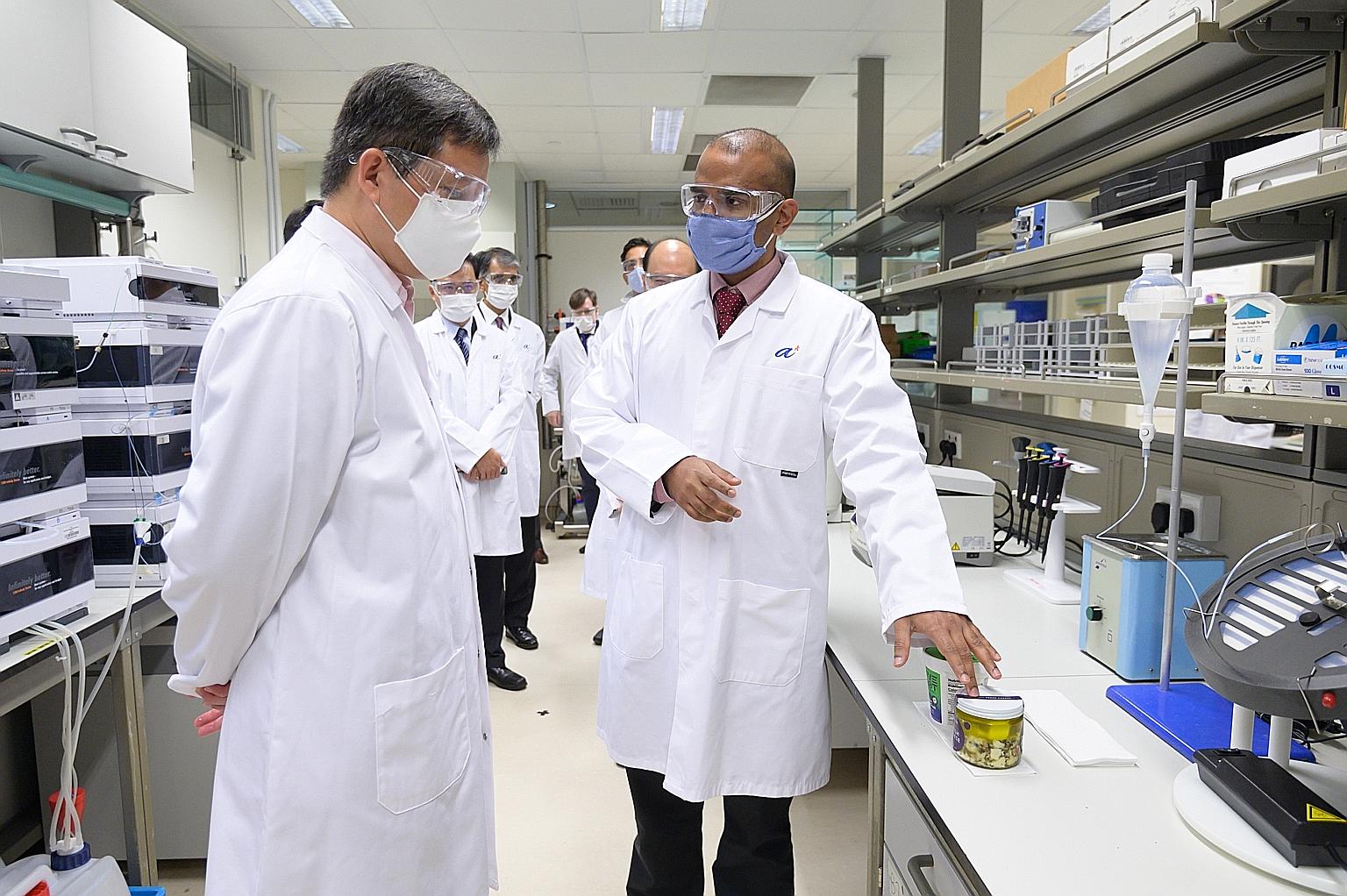 Perfect Day co-founder Perumal Gandhi yesterday showing Trade and Industry Minister Chan Chun Sing some of the alternative protein company's products, which are made with its animal-free dairy proteins.