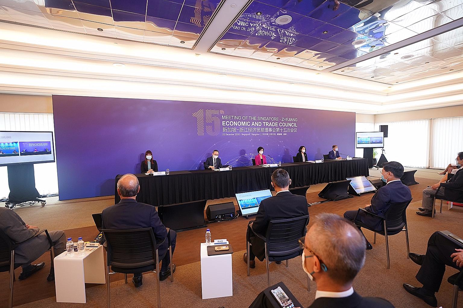 Senior Minister of State for Communications and Information Sim Ann (in red) in a virtual meeting with Zhejiang Vice-Governor Zhu Congjiu yesterday. She said three areas that the two sides are working on - trade and connectivity, innovation, and sust