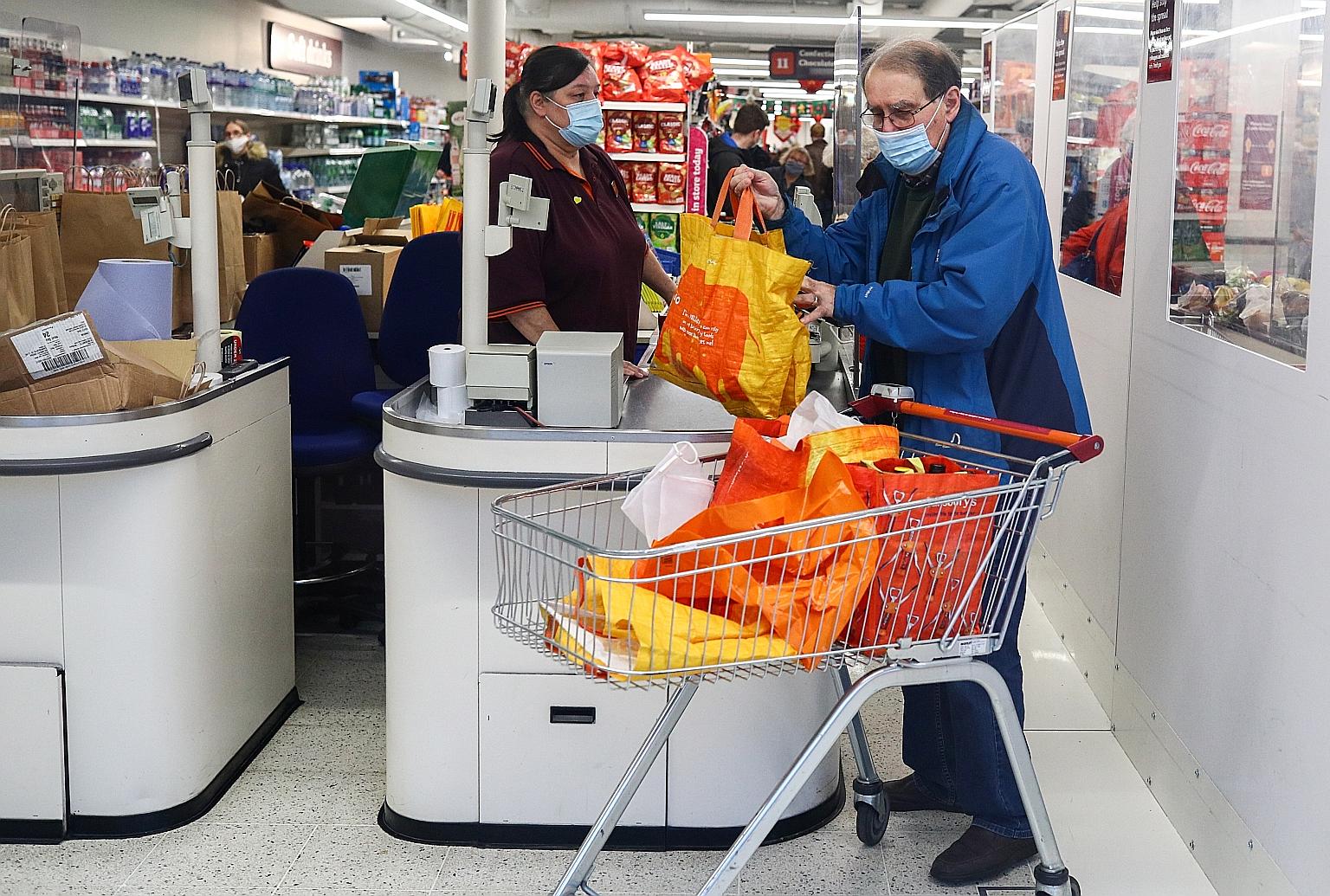 Shoppers at a London supermarket yesterday. The new variant in Britain is one among many that have arisen as the coronavirus spreads worldwide. PHOTO: REUTERS