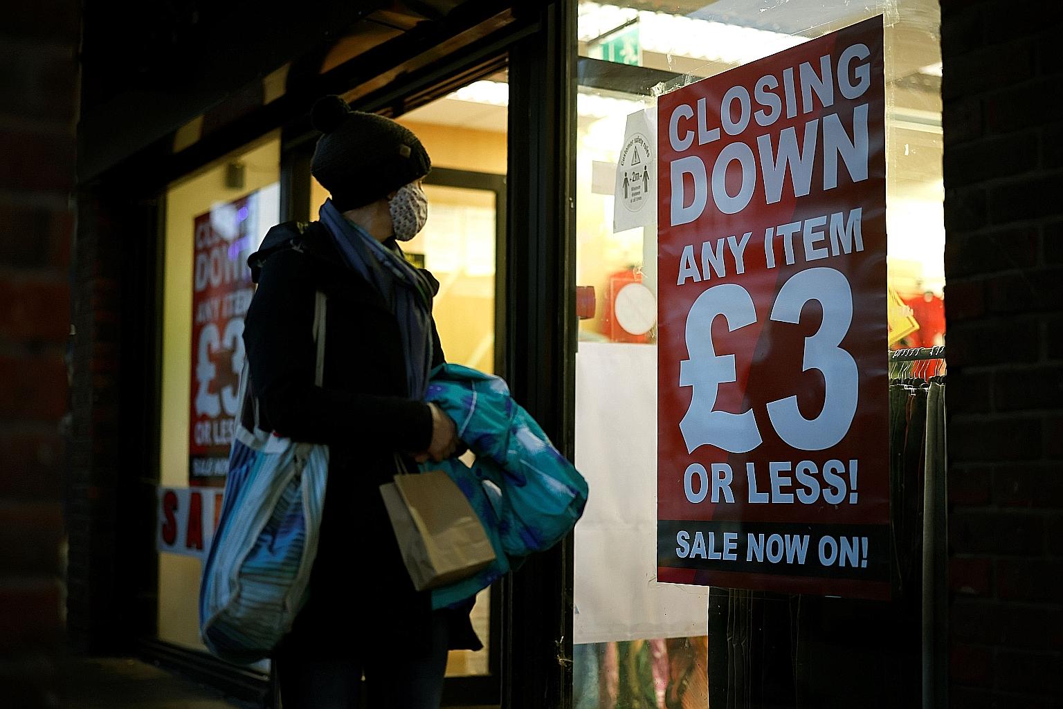 A shopper outside a shop with a "closing down" sign in Walthamstow, north-east London. Almost 40,000 companies - selling both online and in stores - are in "significant financial distress", according to a survey by Begbies Traynor Group.