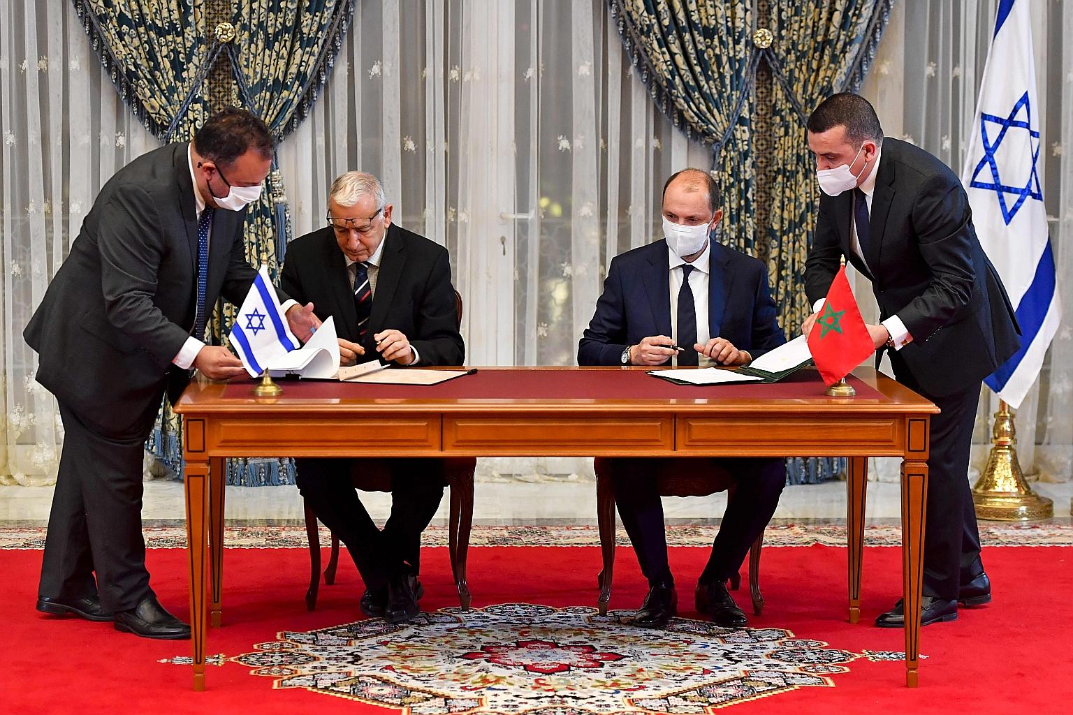 Israel's Population and Immigration Authority director-general Shlomo Mor-Yosef (seated, left) and Mr Mohcine Jazouli, Minister-delegate to Morocco's Minister for Foreign Affairs, signing an agreement at the Royal Palace in the Moroccan capital Rabat