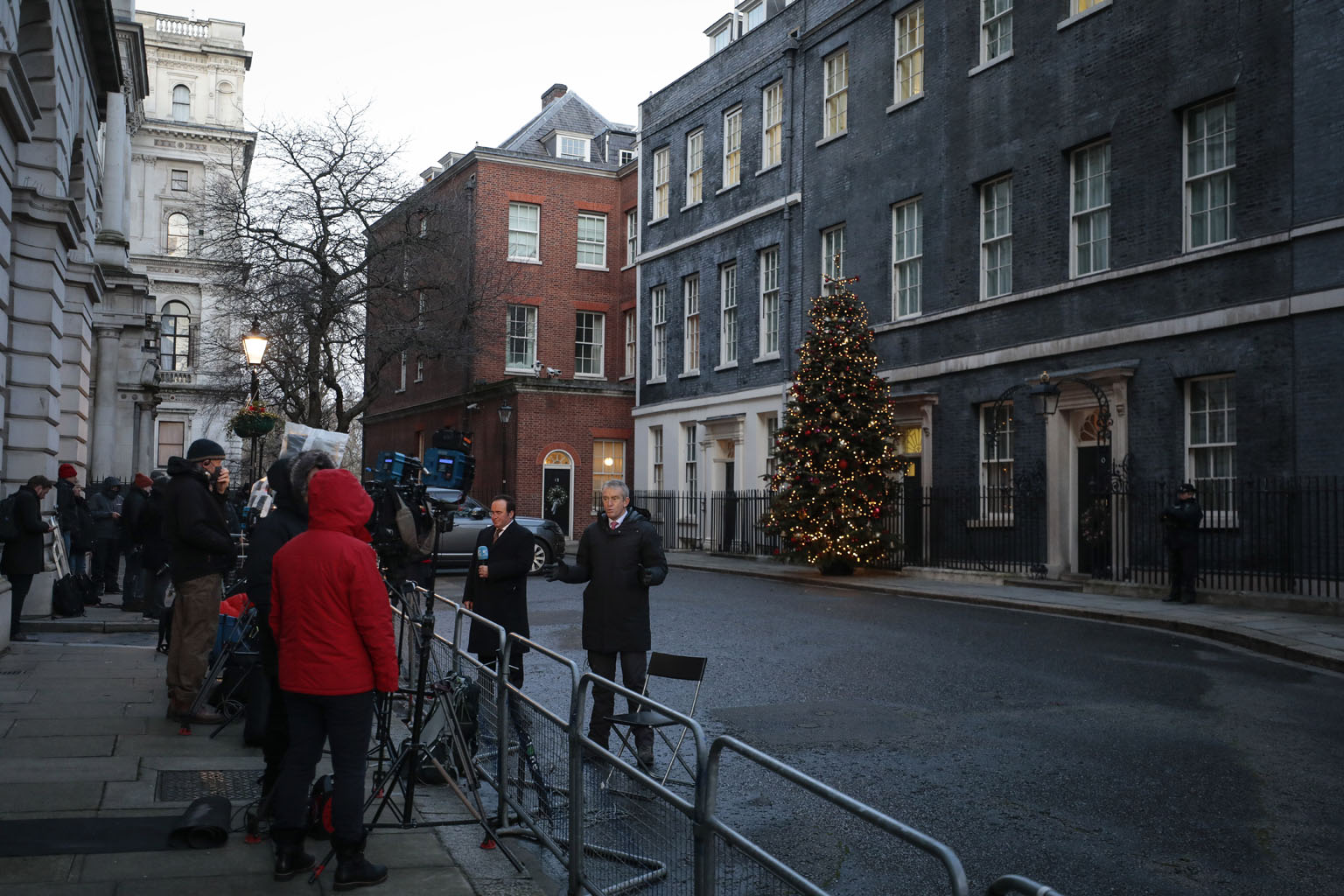 Reporters gathering outside London's 10 Downing Street, the home of Prime Minister Boris Johnson, yesterday. The United Kingdom and the European Union are on the verge of unveiling a narrow post-Brexit trade accord as negotiators worked through the n