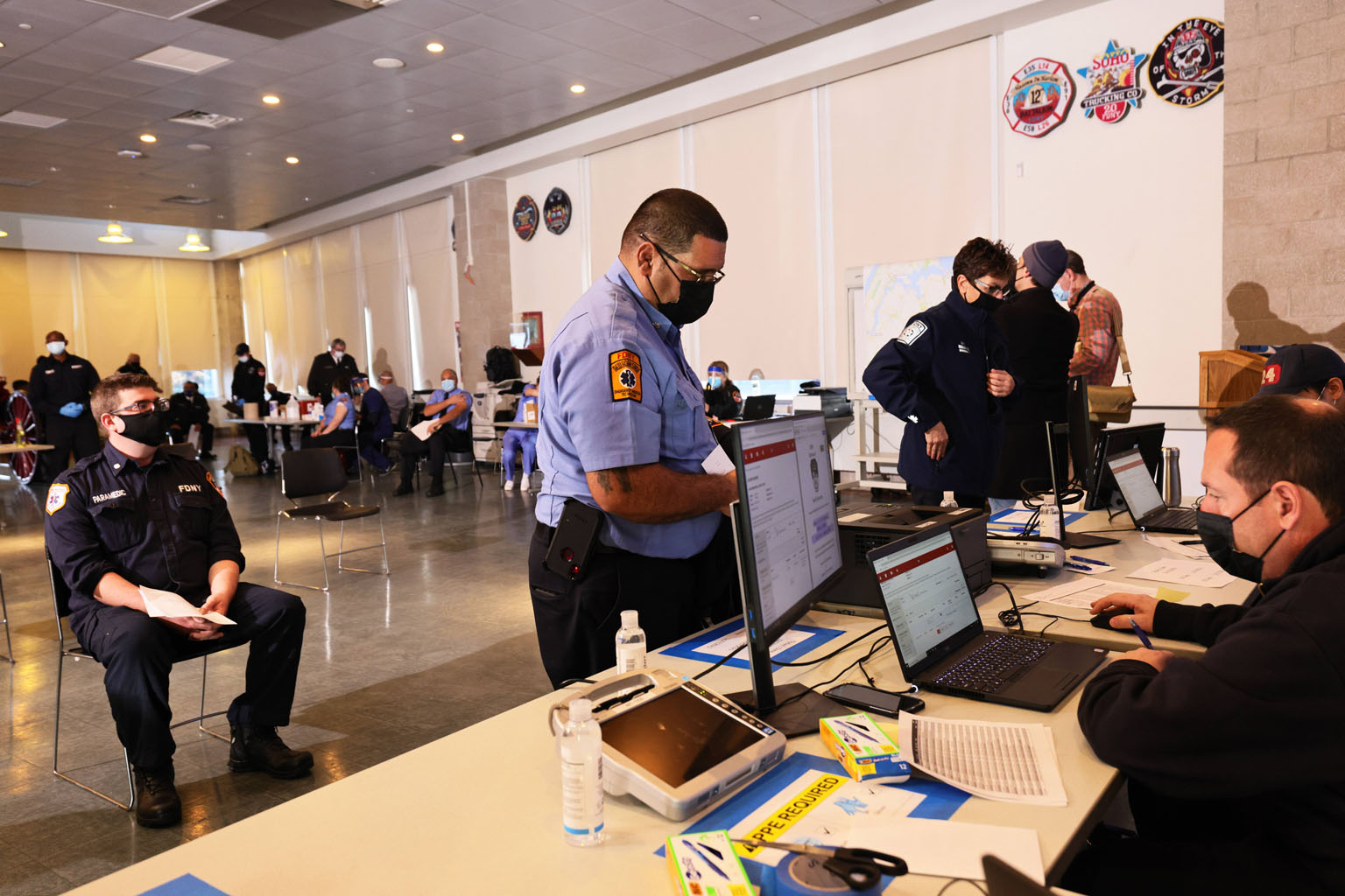 A member of the New York City Fire Department's Bureau of Emergency Medical Services checking out after receiving the coronavirus vaccine on Wednesday in New York City. Firefighters who are considered essential front-line workers but not essential he