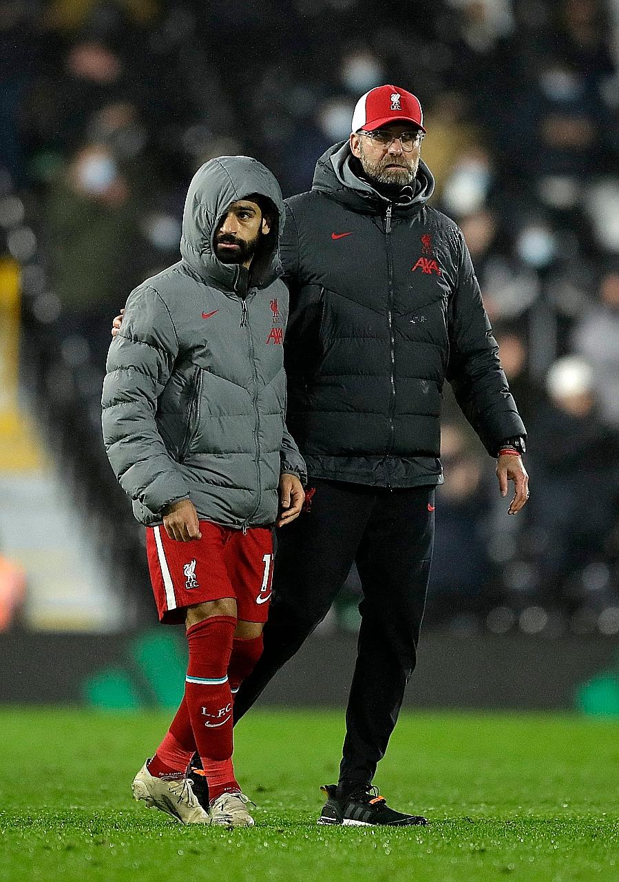 Liverpool forward Mohamed Salah (with manager Jurgen Klopp at Craven Cottage on Dec 13) has scored 13 goals in as many EPL matches. He missed just one game because of Covid-19 isolation.