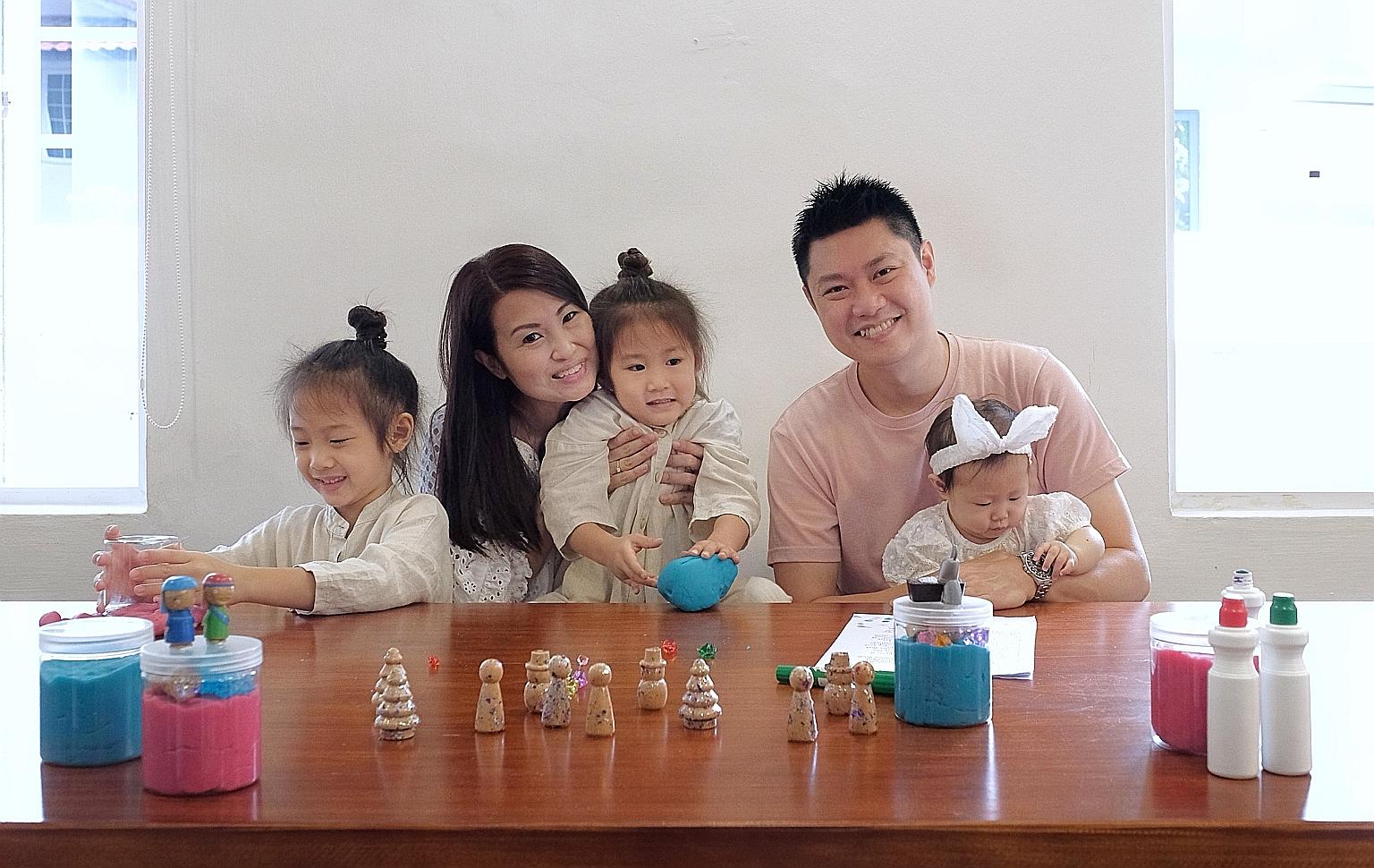 Mrs Eve You, her husband, Mr You Wee Wee, and their children - Kyle (left), five, Rhys (centre), three, and Thea, seven months old - playing with their homemade play-dough, which they sold to raise funds for a children's charity.