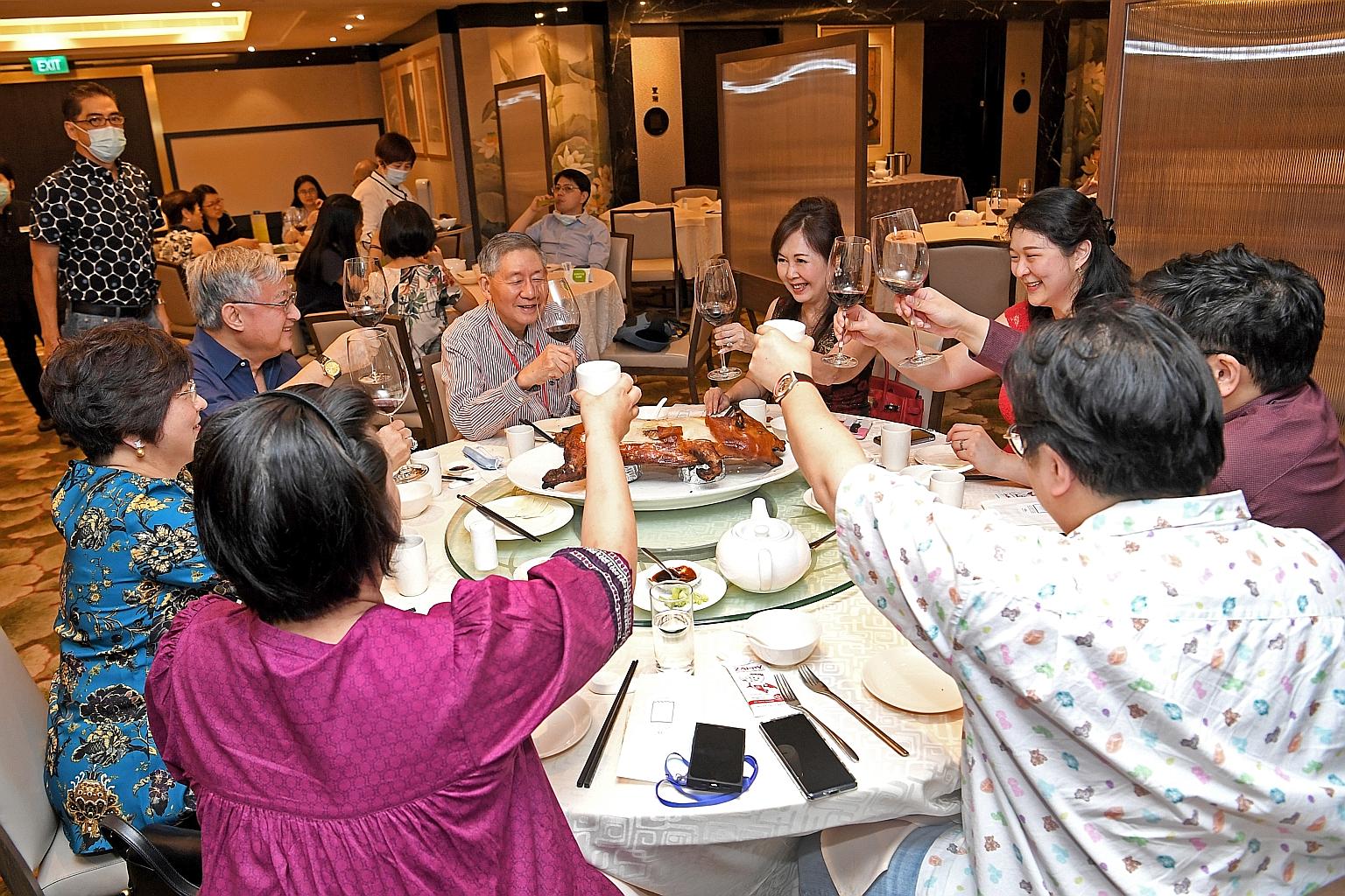 Mrs Laura Hwang (fourth from right) celebrating her birthday with her family at TungLok Signatures restaurant in Orchard Rendezvous Hotel yesterday, as Singapore entered phase three of its reopening. Groups of up to eight people can now gather social