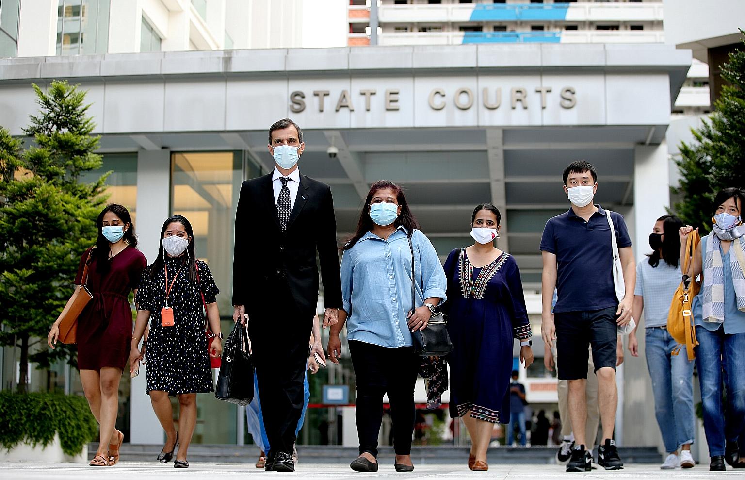 Former domestic worker Parti Liyani (centre, in light blue top), seen here leaving the State Courts in September with her lawyer Anil Balchandani, became a household name when she was acquitted of stealing from her wealthy and powerful employer.