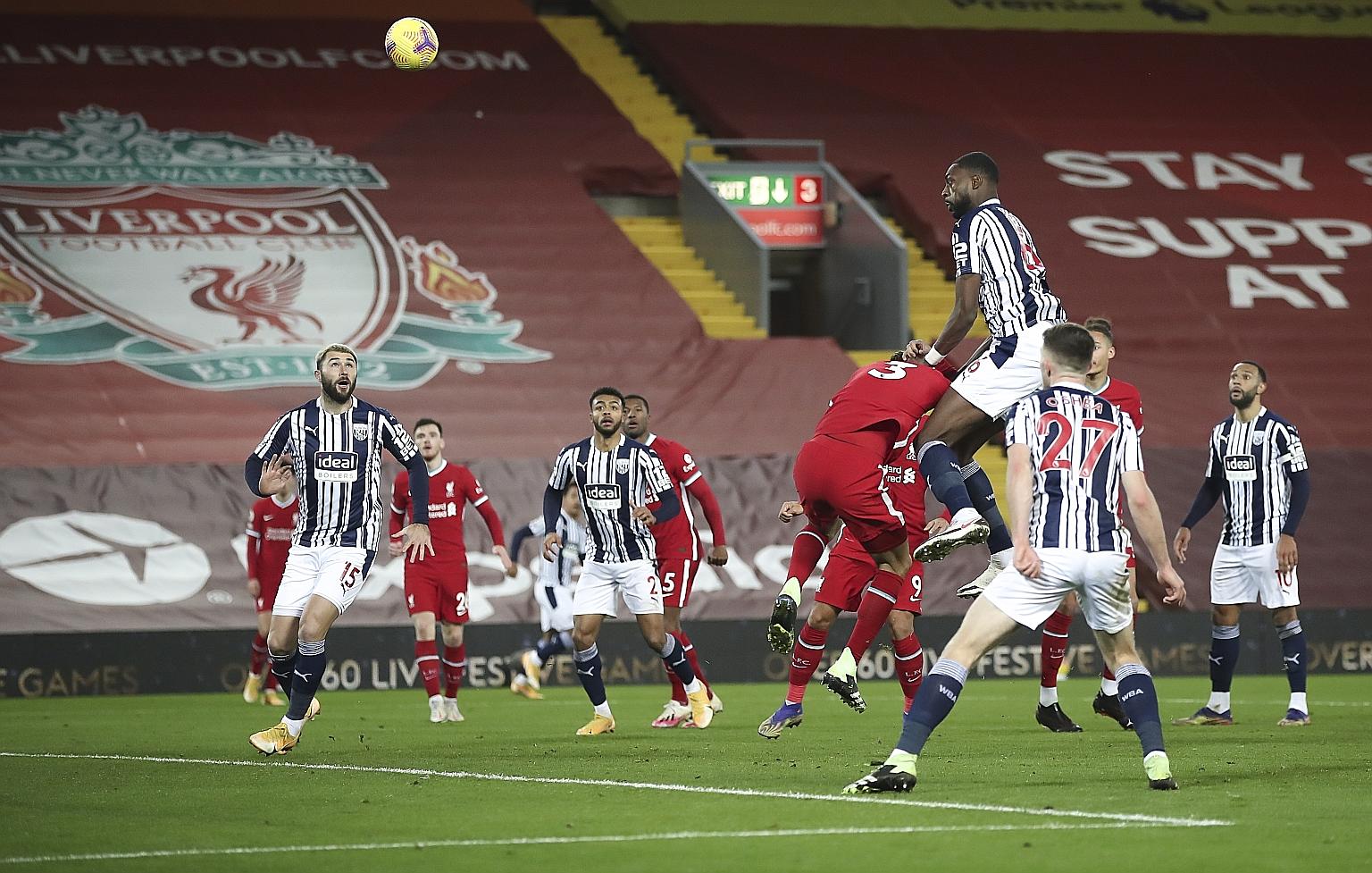 Semi Ajayi outleaps the Liverpool defence to score a late equaliser and earn embattled West Brom a point at Anfield on Sunday. Sadio Mane had given the Reds an early lead. PHOTO: EPA-EFE
