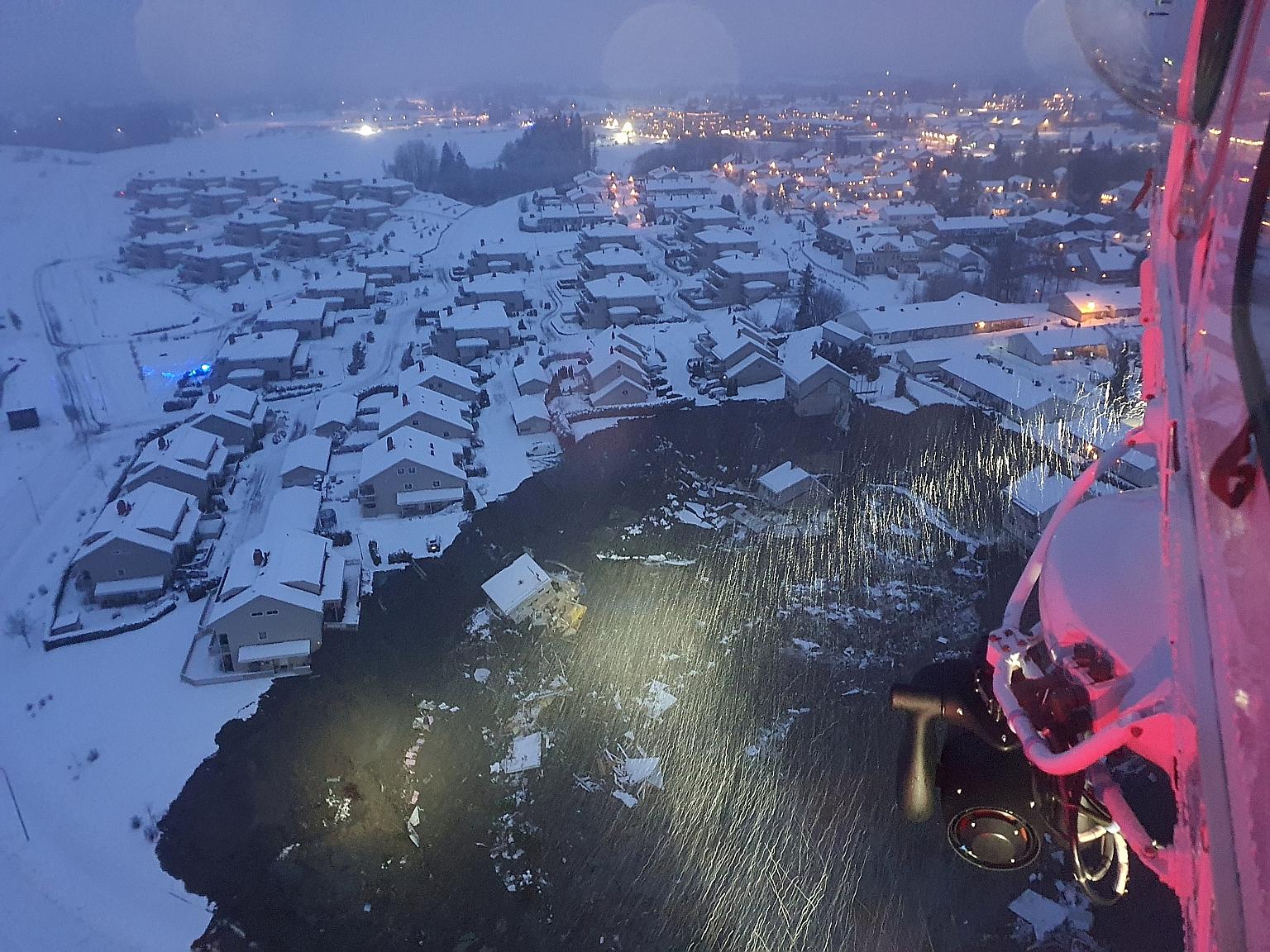 A helicopter view of the site of the landslide, showing a large crater with destroyed buildings at the bottom of it, in the municipality of Gjerdrum, Norway, yesterday. About 700 people have been evacuated from the area. PHOTO: REUTERS