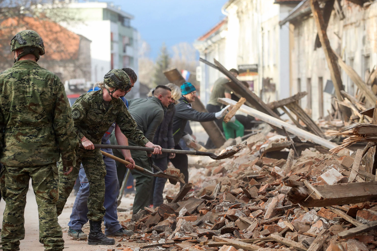 People clearing rubble in Petrinja, about 50km from Croatia's capital Zagreb, after a 6.4-magnitude tremor on Tuesday devastated the town and left residents homeless.