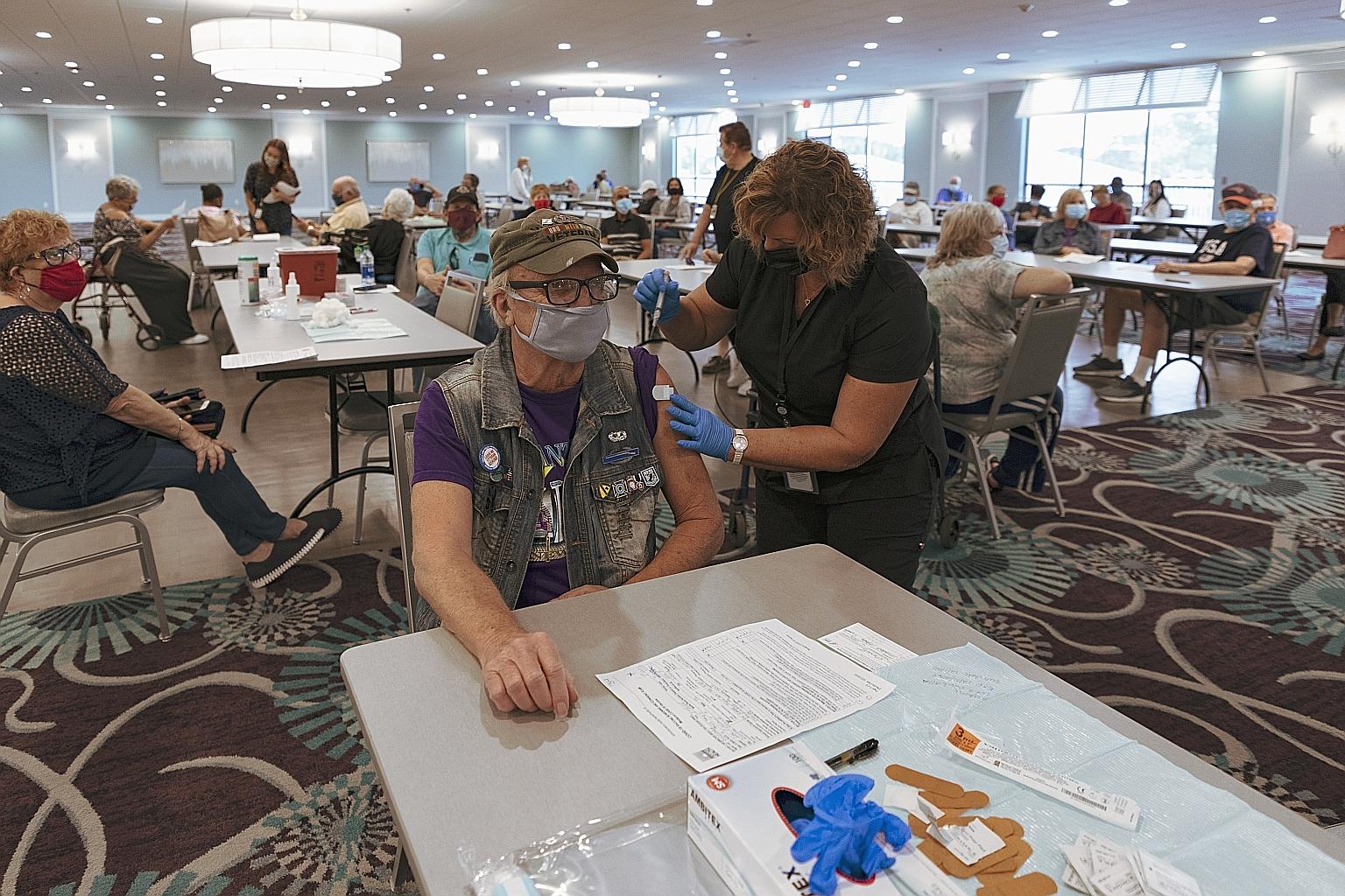 A resident receiving the Moderna Covid-19 vaccine at the King's Point retirement home in Delray Beach, Florida, on Wednesday. Only about 2.8 million Americans had been vaccinated as at Wednesday evening, representing around 13.5 per cent of the autho