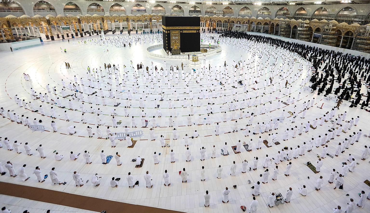 Muslim worshippers praying around the Kaaba in the Grand Mosque complex in Mecca, Islam's holiest shrine, in Saudi Arabia. Millions of Muslims from across the world travel to Saudi Arabia on umrah pilgrimages throughout the year. These involve making