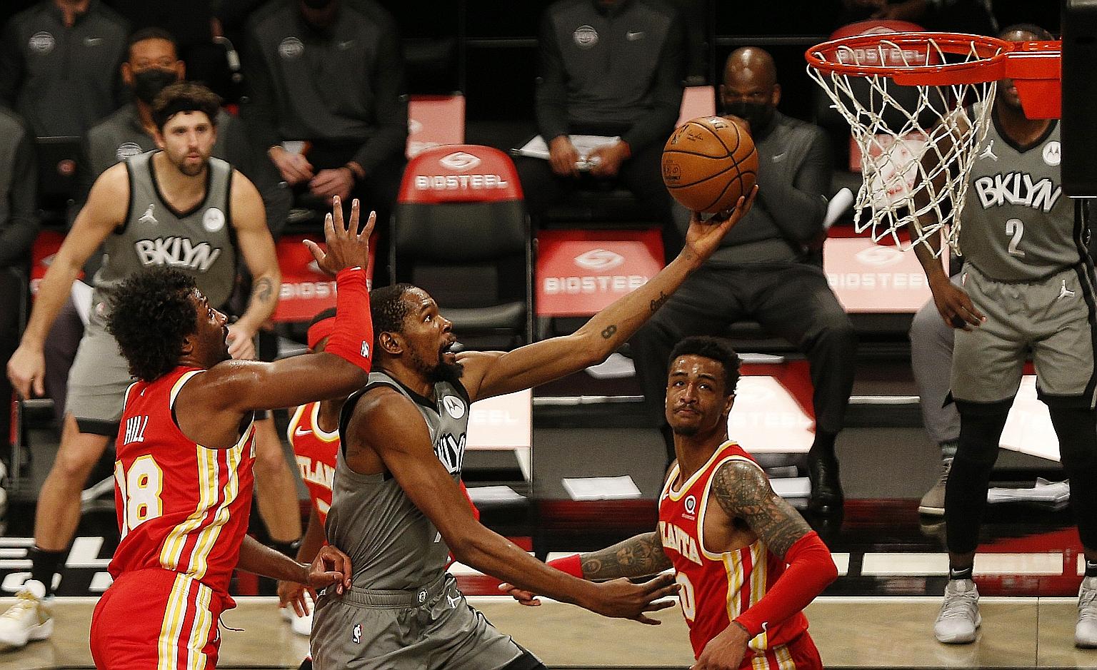 Brooklyn Nets forward Kevin Durant driving to the basket while being defended by Atlanta Hawks forward Solomon Hill. The Nets won 145-141 and improved to 3-2 in the Eastern Conference.
