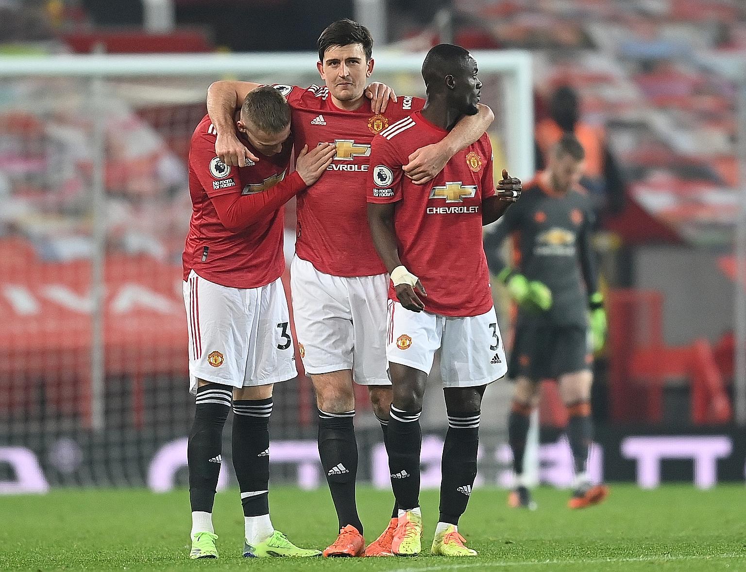 Scott McTominay (left), Harry Maguire (centre) and Eric Bailly celebrating United's 1-0 home win over Wolves that took them to second in the table.