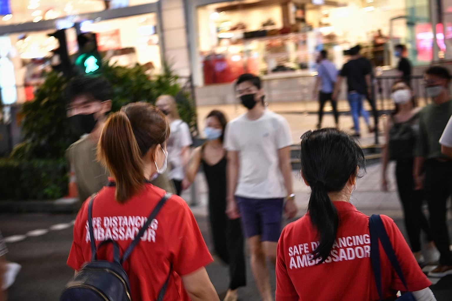 Safe distancing ambassadors in Singapore remind people to adhere to measures put in place to stem the spread of the coronavirus. These measures include the wearing of masks, restrictions on group sizes, and keeping a 1m distance between groups. ST PH