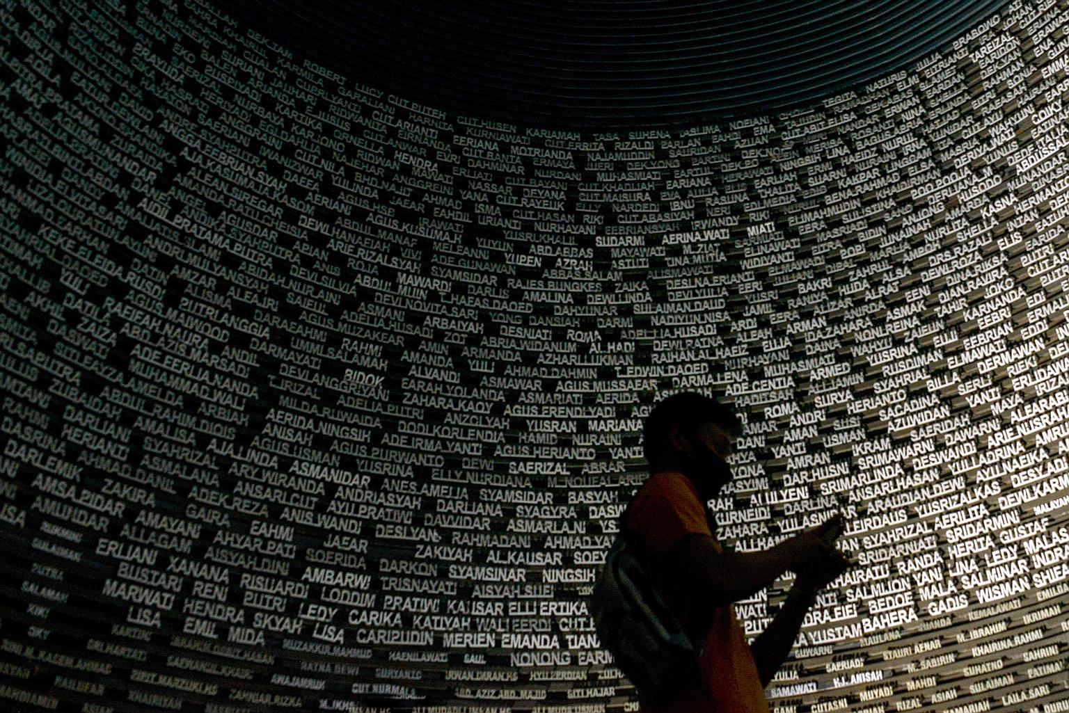 People visiting a hall with a list of names at the Tsunami Museum in Indonesia's Banda Aceh yesterday, following the 16th anniversary of the disaster last week. The hall is dedicated to victims of the 2004 Boxing Day tsunami that killed around 170,00