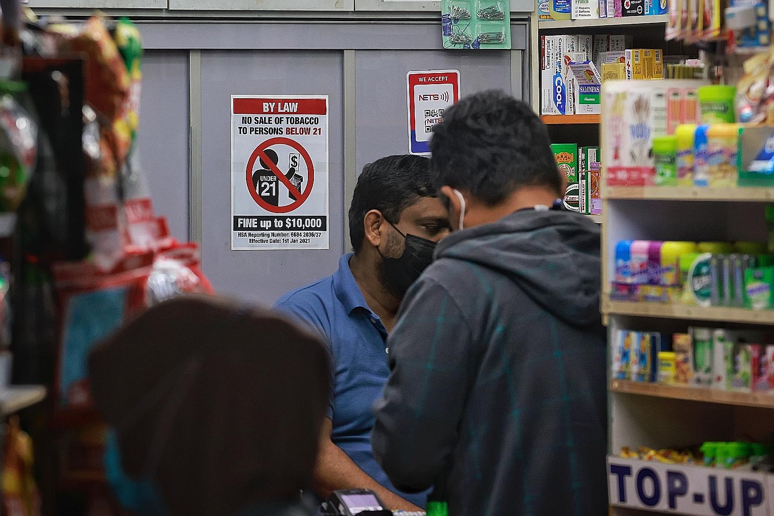 A sign in a convenience store at Bedok Interchange Food Centre showing the updated minimum age of 21 for people buying tobacco products. Other measures in the Government's anti-smoking arsenal include public education, taxation, cessation programmes