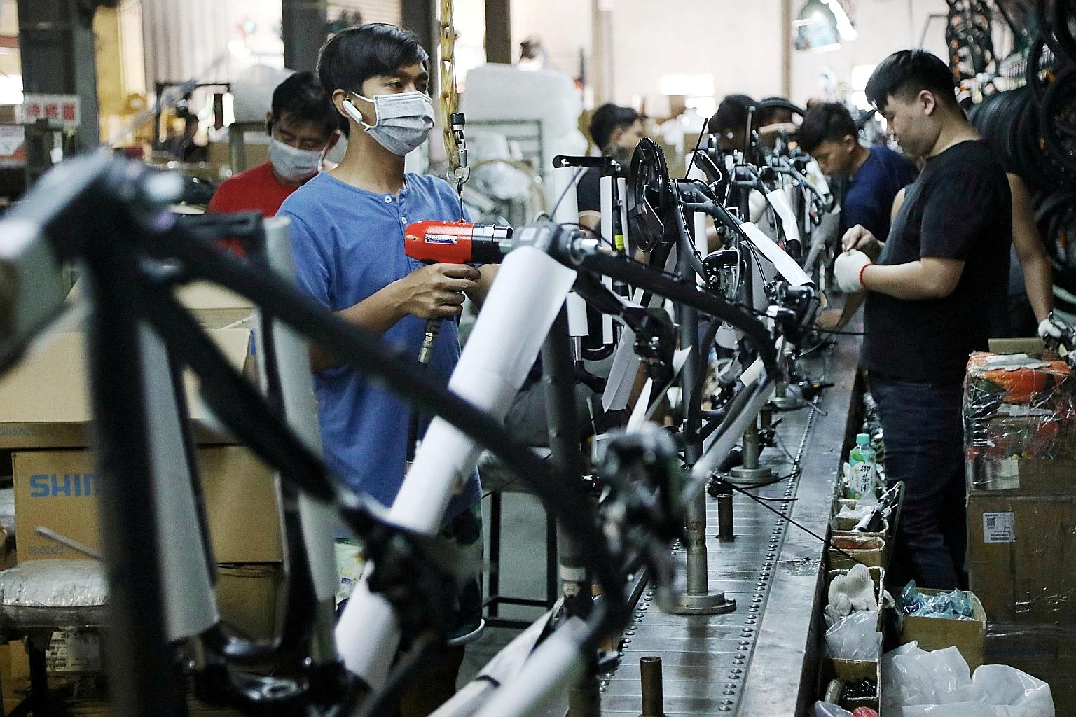 Workers in a bicycle factory belonging to Acetrikes Industrial in Changhua, Taiwan. Robust demand in China helped manufacturing activity rise in neighbouring economies such as Taiwan, Japan and South Korea, according to Purchasing Managers' Index sur