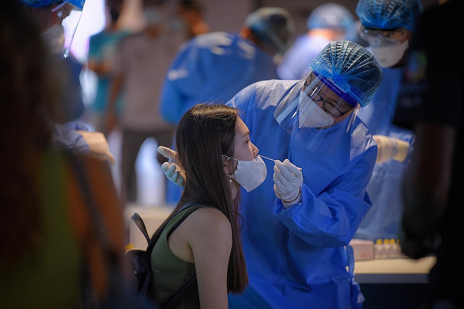 A spectator taking an antigen rapid test for Covid-19 before a football match between Tampines Rovers and Geylang International at Our Tampines Hub on Dec 5.