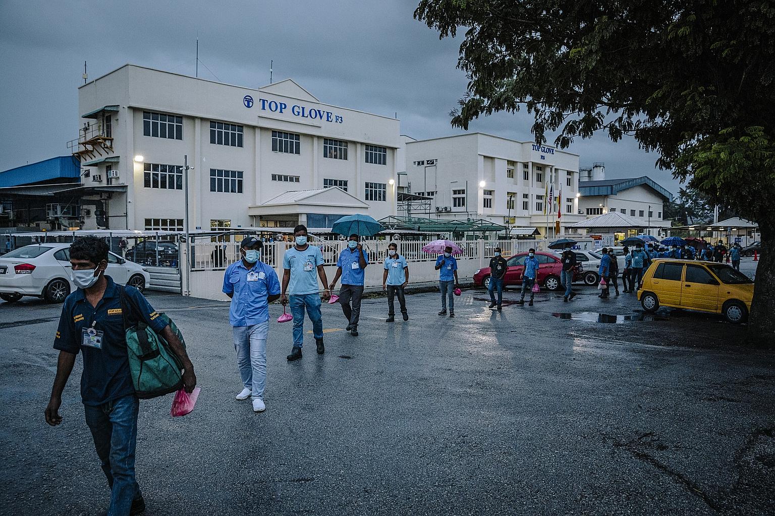 Top Glove workers leaving the company's factory in Klang. More than 5,000 of the Malaysian firm's foreign workers were infected with Covid-19 and one died. Workers have spoken up about their poor working and living conditions, such as crowded dormito