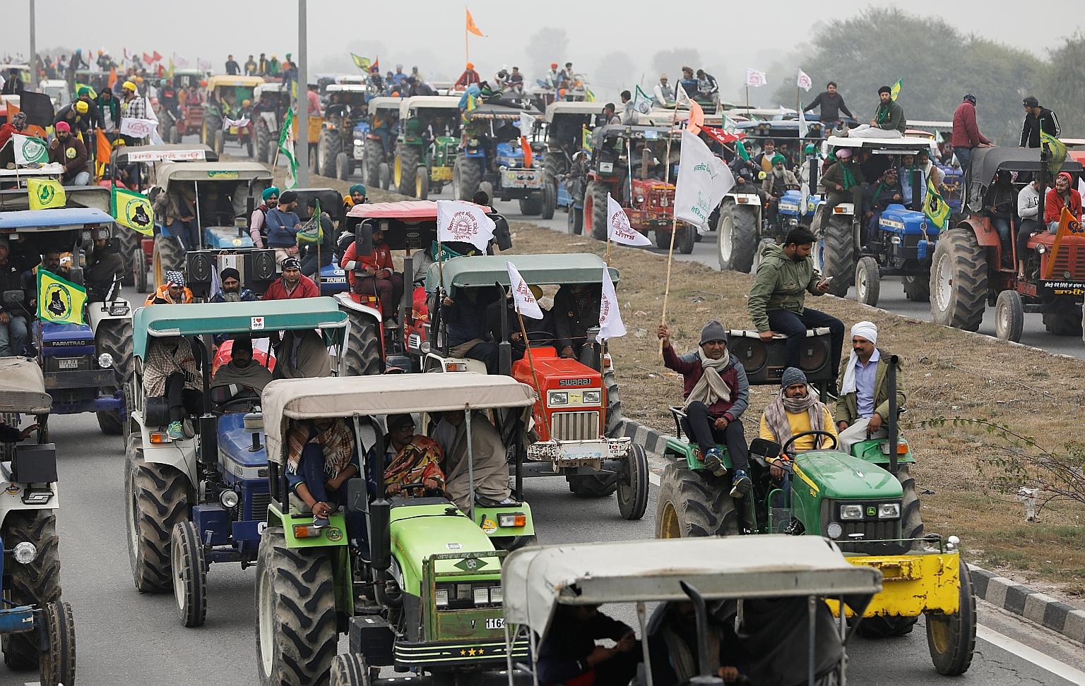 In one of the biggest shows of strength, farmers participating in a tractor rally to protest against three new farm laws, at Singhu border near New Delhi, yesterday. PHOTO: REUTERS