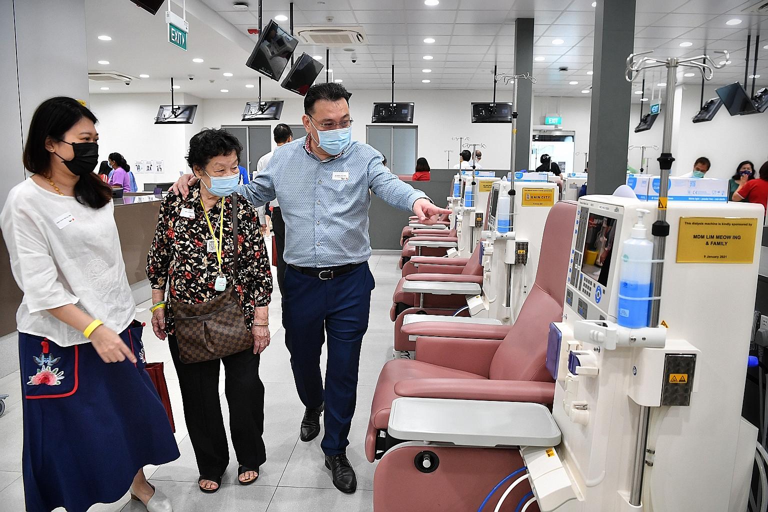 Mr Kenny Teo, managing director of Gain City, with his mother Lim Meow Ing and wife Chiam Bee Ling yesterday at the National Kidney Foundation's new dialysis centre in Yuhua, to which he donated two dialysis machines - one under Gain City's name, and
