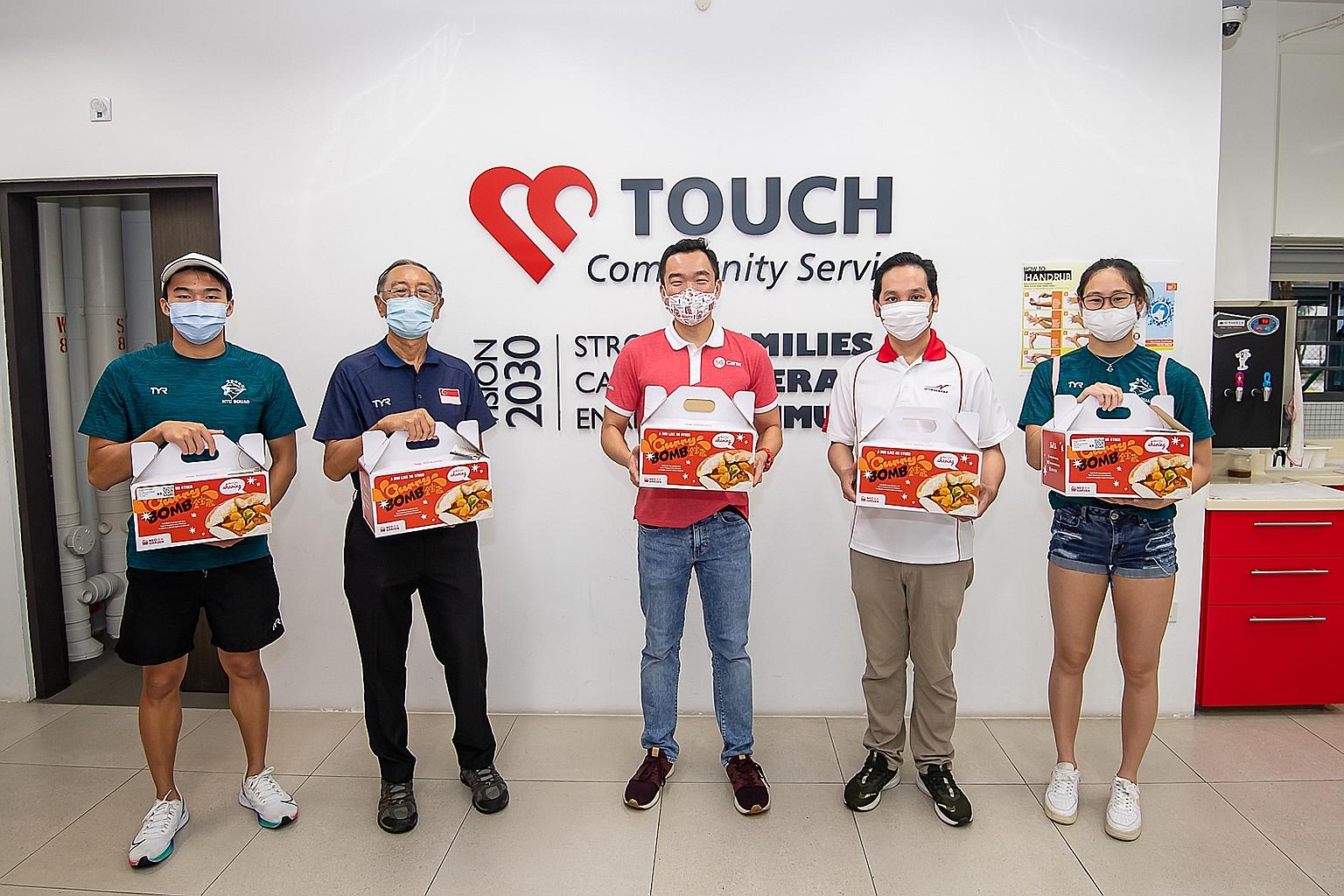 More than 180 of the Singapore Swimming Association's (SSA) athletes, coaches, officials, parents and affiliates delivered curry bombs yesterday to 500 families within the SG Cares Volunteer Centres and community partner networks. Among them were (fr