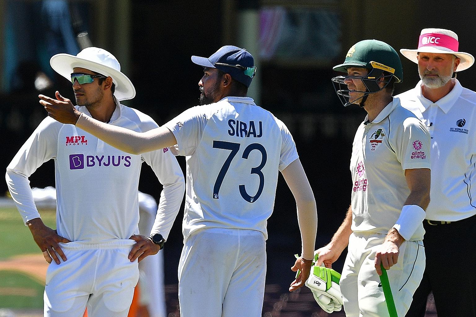India's Mohammed Siraj telling Australia captain Tim Paine about offending remarks made by fans during the third cricket Test match in Sydney on Sunday.