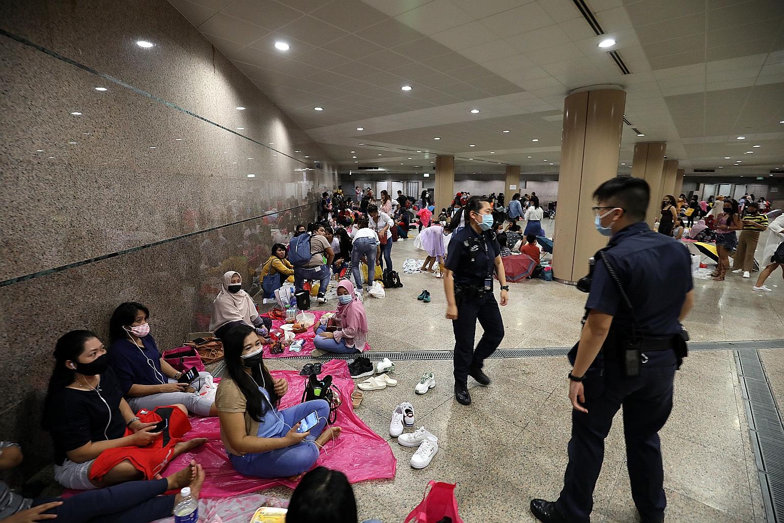 Police seen dispersing crowds at the Esplanade underpass on Sunday afternoon. Many people had gathered at the underpass which connects CityLink Mall and Esplanade - Theatres on the Bay to avoid the heavy downpour, the Chinese-language daily Lianhe Za