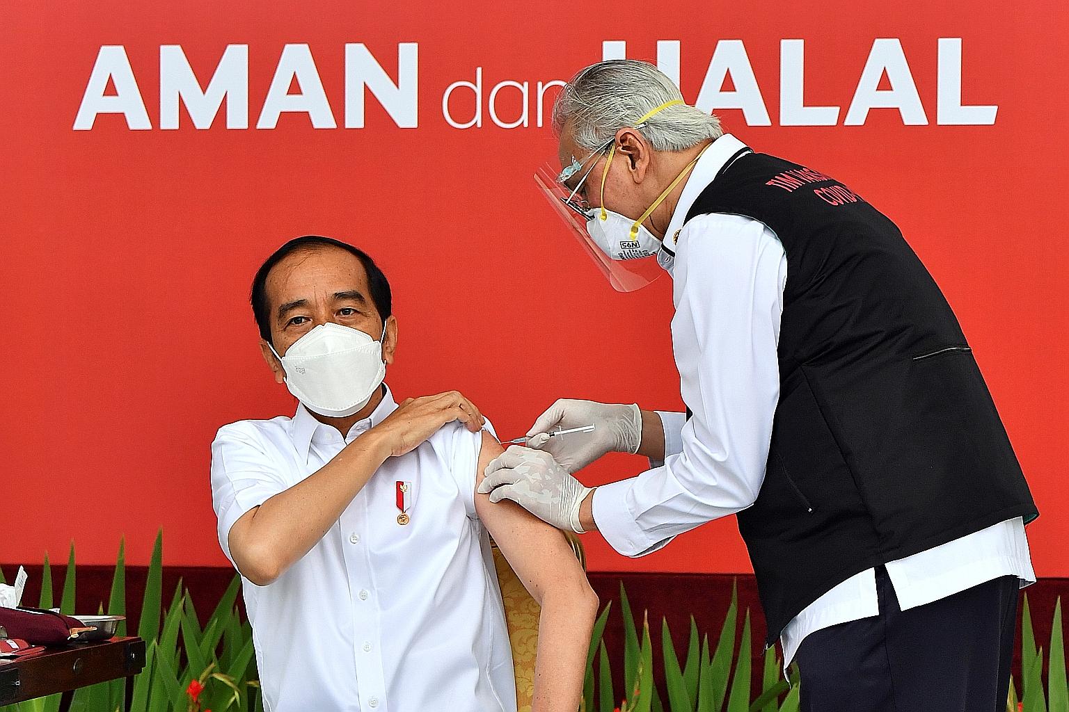 Indonesian President Joko Widodo receiving his first dose of the vaccine developed by China's Sinovac Biotech at the presidential palace in Jakarta yesterday. Mr Joko was the first person in the country to have a Covid-19 shot, to give Indonesians th