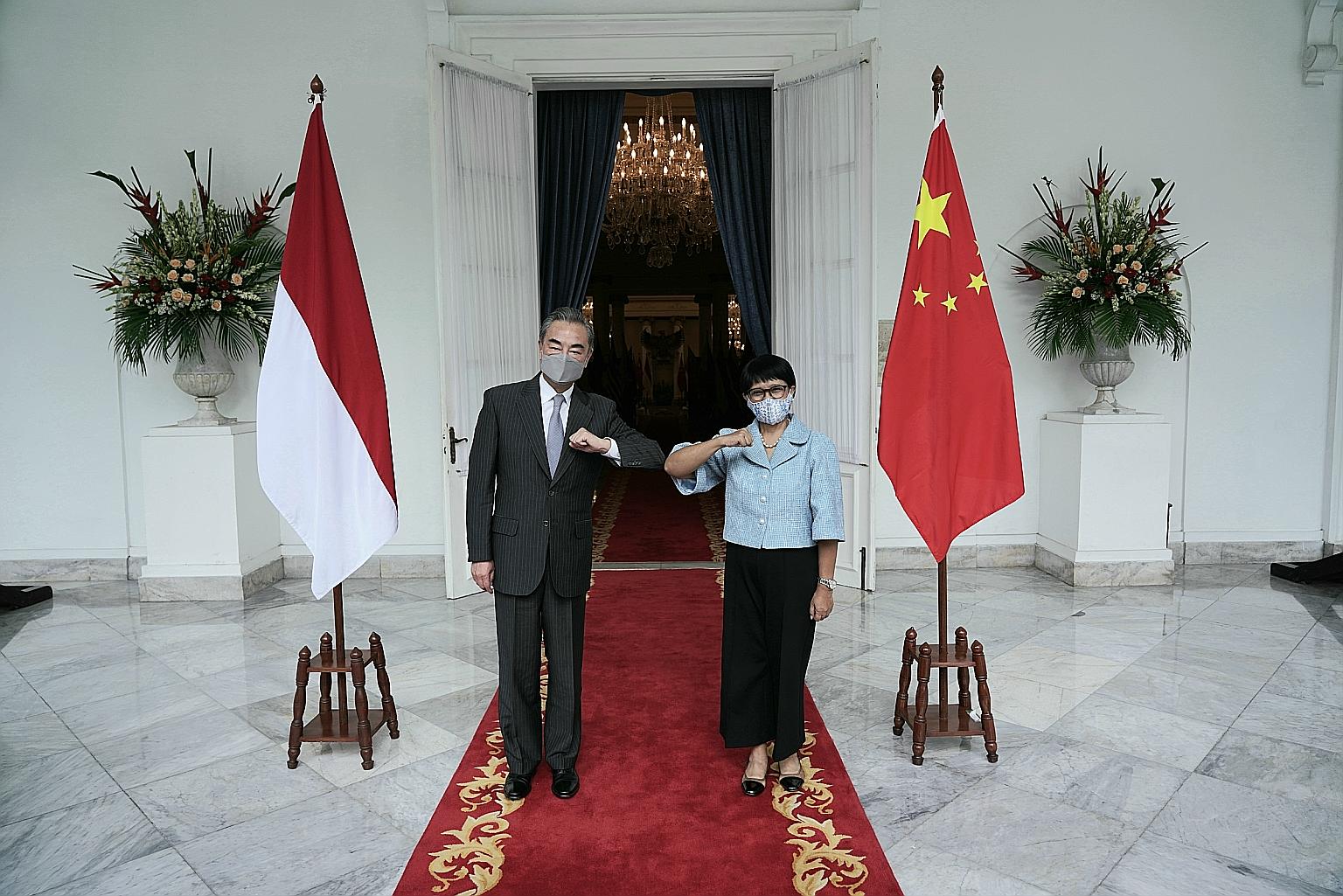 Chinese Foreign Minister Wang Yi with Indonesian Foreign Minister Retno Marsudi in Jakarta yesterday. Mr Wang said China "is prepared to continue (vaccine) production cooperation with Indonesia... and will support Indonesia to become a regional produ