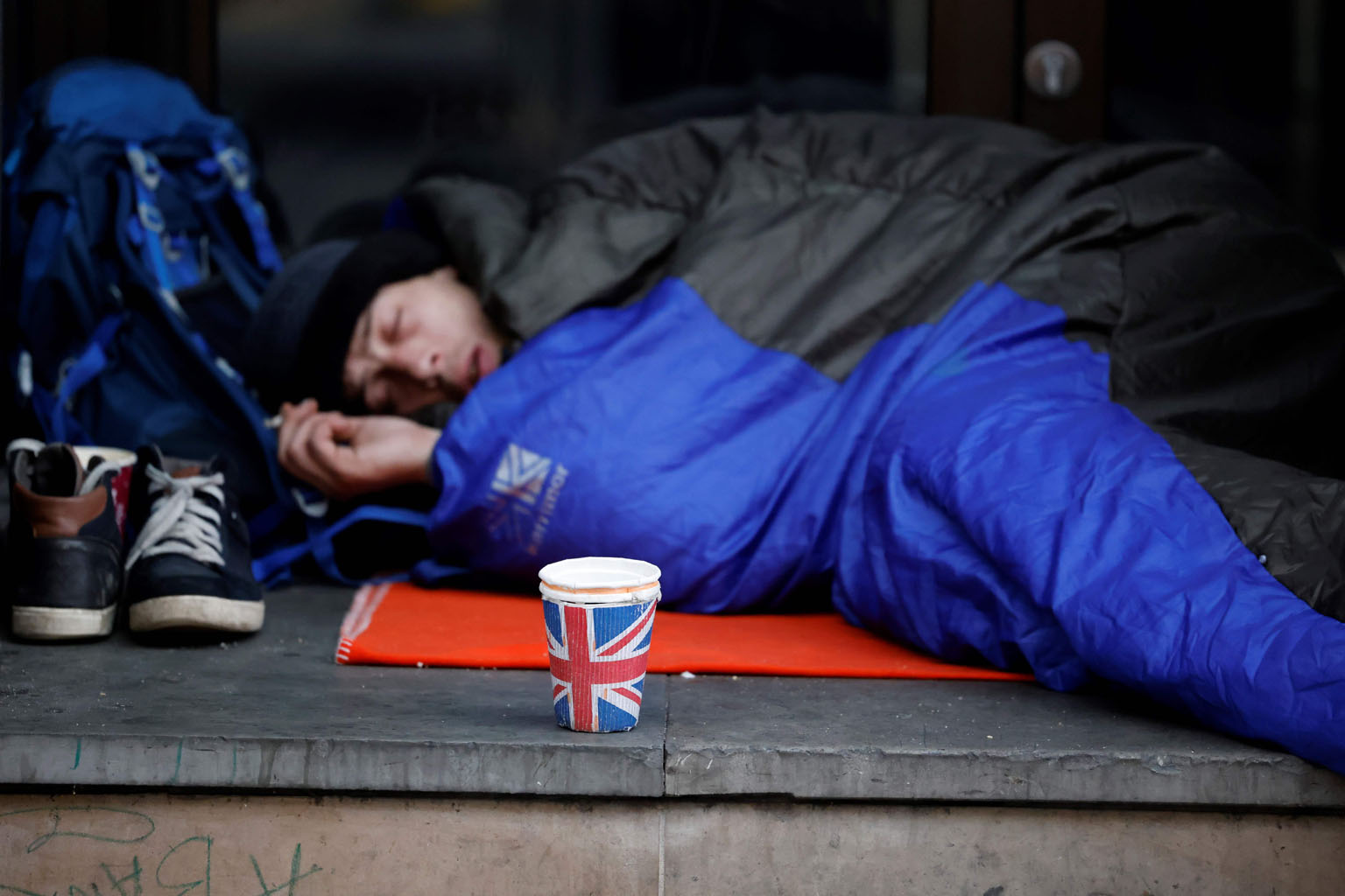 A homeless person sleeping on a pavement near Piccadilly Circus in central London in November. A drop in welfare payments called Universal Credit could see millions of people lose out on aid from what is already one of the developed world's least gen