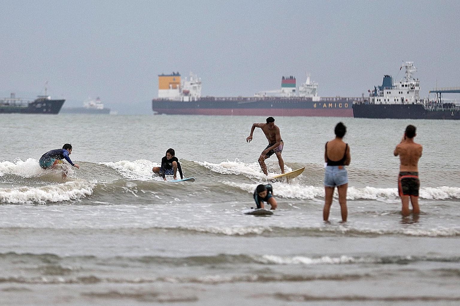 Surfers in Singapore who have been thwarted in chasing the waves overseas by Covid-19 travel restrictions have been flocking to one of the known surf spots in the country. Around 20 surfers were seen there yesterday afternoon - a beach near the Natio