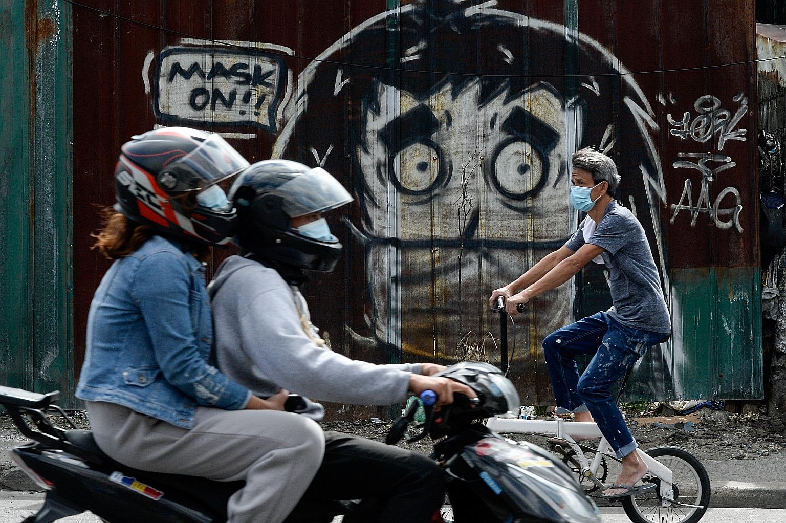 A mural reminding people to wear their masks in Caloocan City, Philippines. The country has tallied at least 494,000 cases of Covid-19. PHOTO: REUTERS