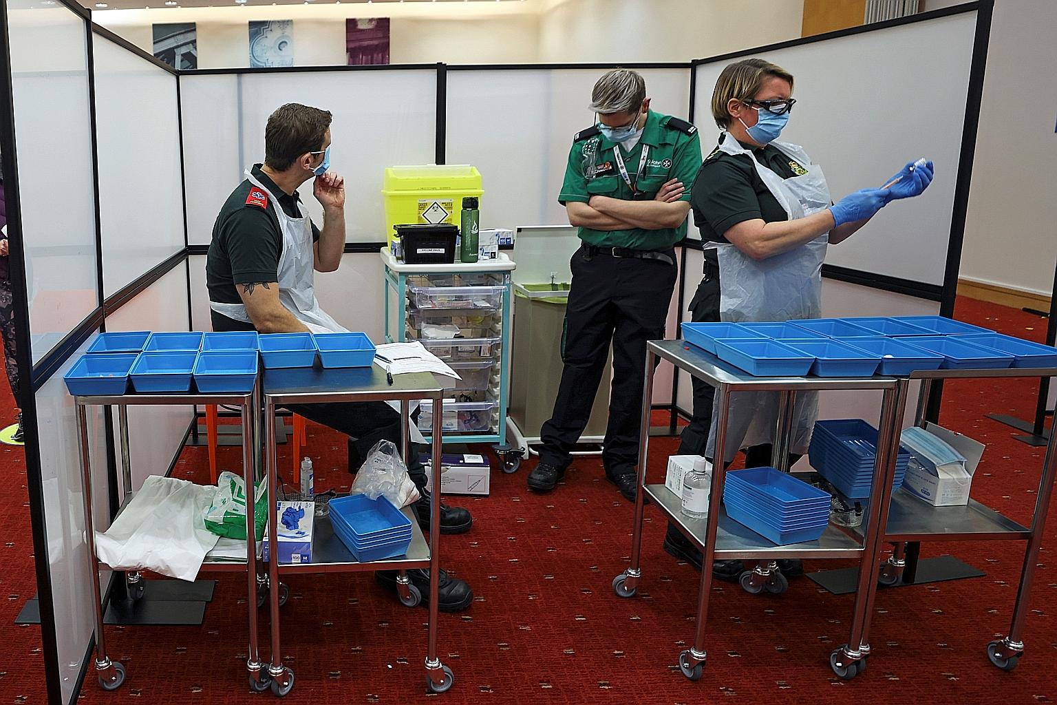 A healthcare worker drawing a dose of Covid-19 vaccine into a syringe at the Centre for Life vaccination hub in the British city of Newcastle on Monday. Health workers are among those most exposed to the coronavirus, as countries across the world hav