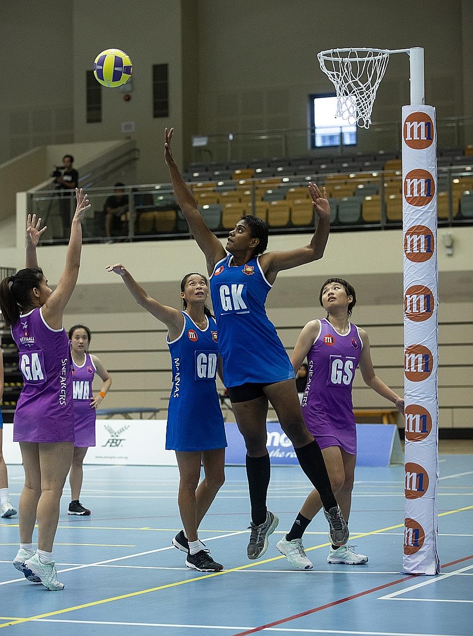 Mission Mannas goalkeeper Ema Mualuvu trying to block a shot by Sneakers Stingrays' goal attack Wong Pei Ying in an NSL game last March. The netballers are trying to stay positive during their modified training sessions while awaiting a decision on t