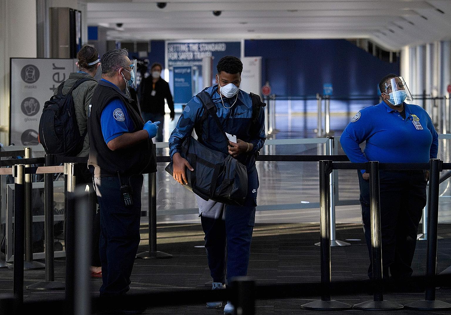 A passenger entering a checkpoint at Los Angeles International Airport. Major US airlines are temporarily banning the checking in of firearms on Washington-area flights, among other steps.
