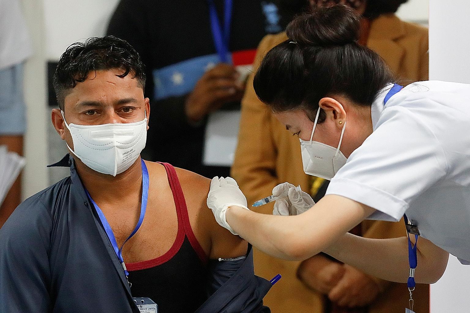 Sanitation worker Manish Kumar took the honour of being the first person in India to be vaccinated. Ten million healthcare workers will be the first to get the vaccine, followed by 20 million front-line workers. PHOTO: REUTERS