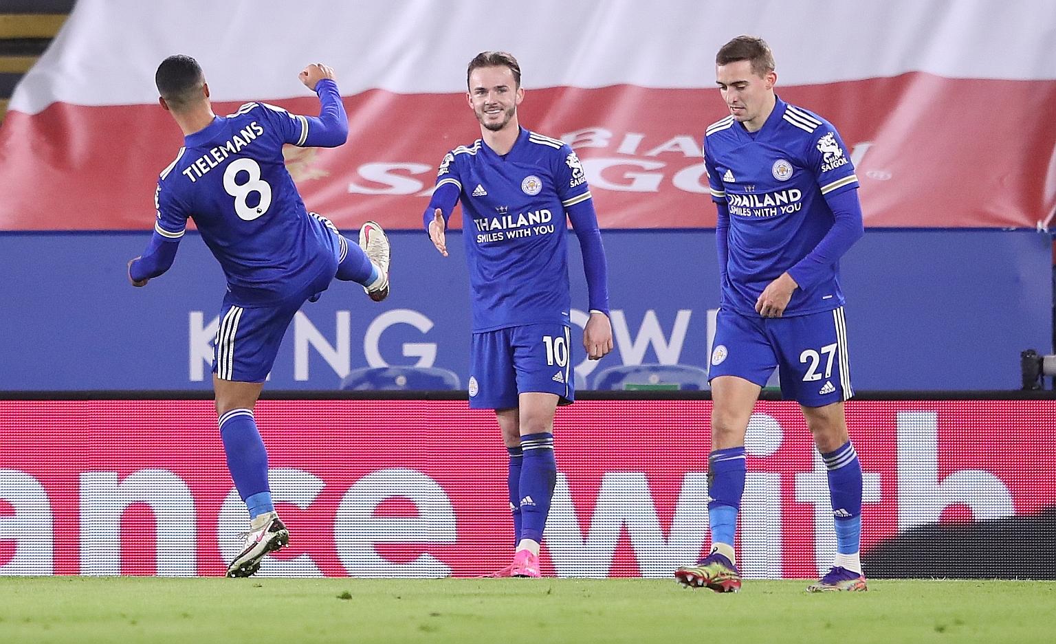 Leicester's James Maddison celebrates with a socially-distanced handshake after scoring the first goal in their 2-0 win over the Saints. PHOTO: EPA-EFE