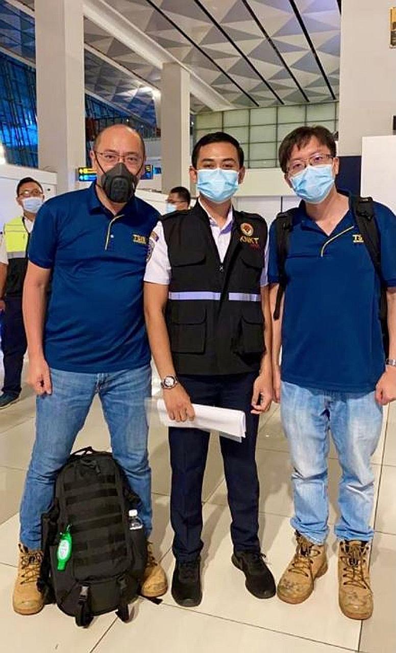 Singapore's Transport Safety Investigation Bureau investigators David Lim (at left) and Alexander Leong (far right) were received by staff from Indonesia's National Transportation Safety Committee at the Jakarta airport last Wednesday. PHOTO: MINISTR