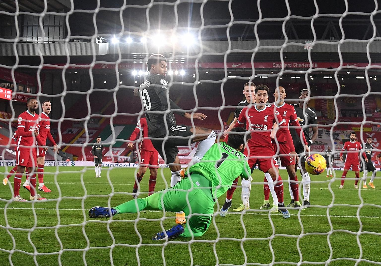 Liverpool's goalkeeper Alisson Becker saving from Marcus Rashford to keep a clean sheet against Manchester United and maintain their 68-game unbeaten top-flight run at Anfield. The match ended 0-0.