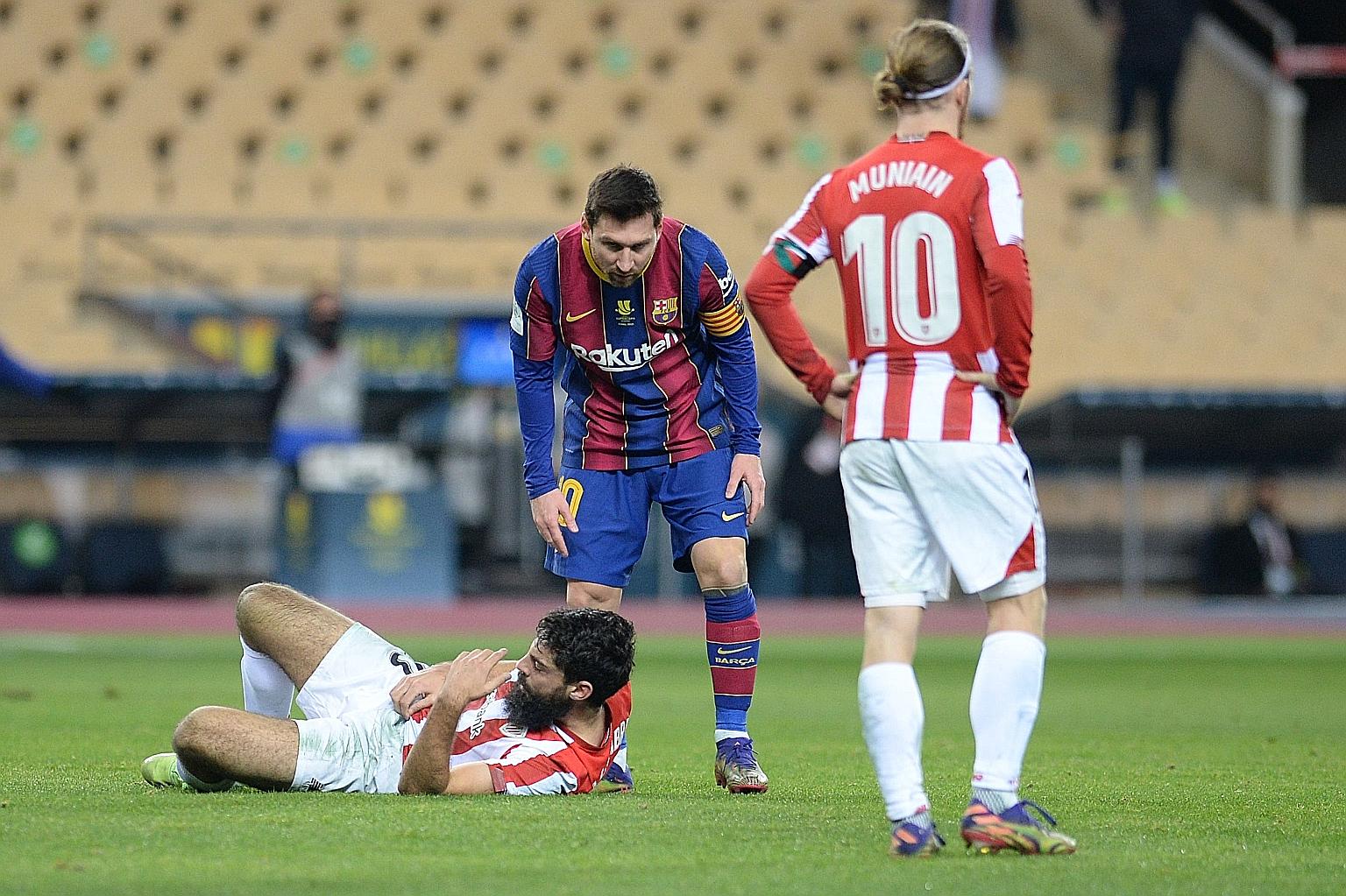 Bilbao's Asier Villalibre on the ground after being hit by Barcelona's Lionel Messi, who was sent off after a VAR review.