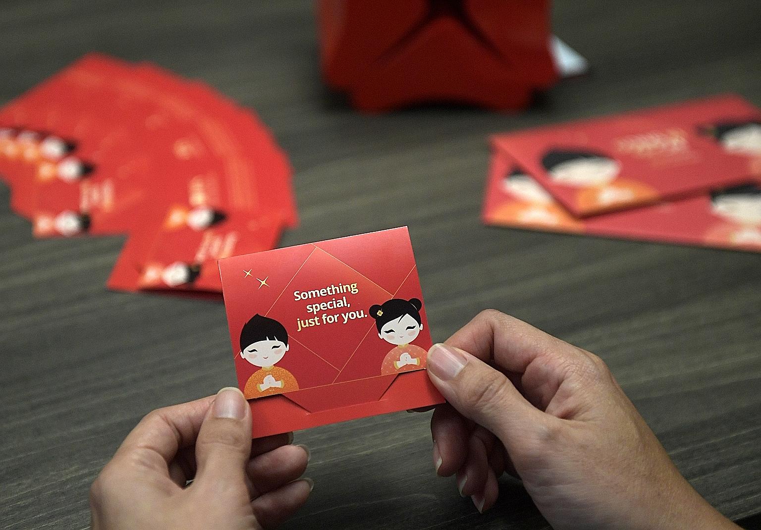 DBS Bank customers have a hybrid option called QR Gift, which involves physical gift cards (above) with QR codes printed on them. ST PHOTO: ALPHONSUS CHERN