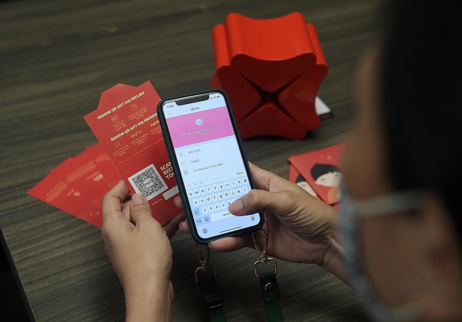 DBS customers have the option of sending their e-hongbao via PayNow or by making use of QR Gift (left), a hybrid option which involves giving out physical gift cards with QR codes printed on them. These codes can then be scanned by recipients to rece