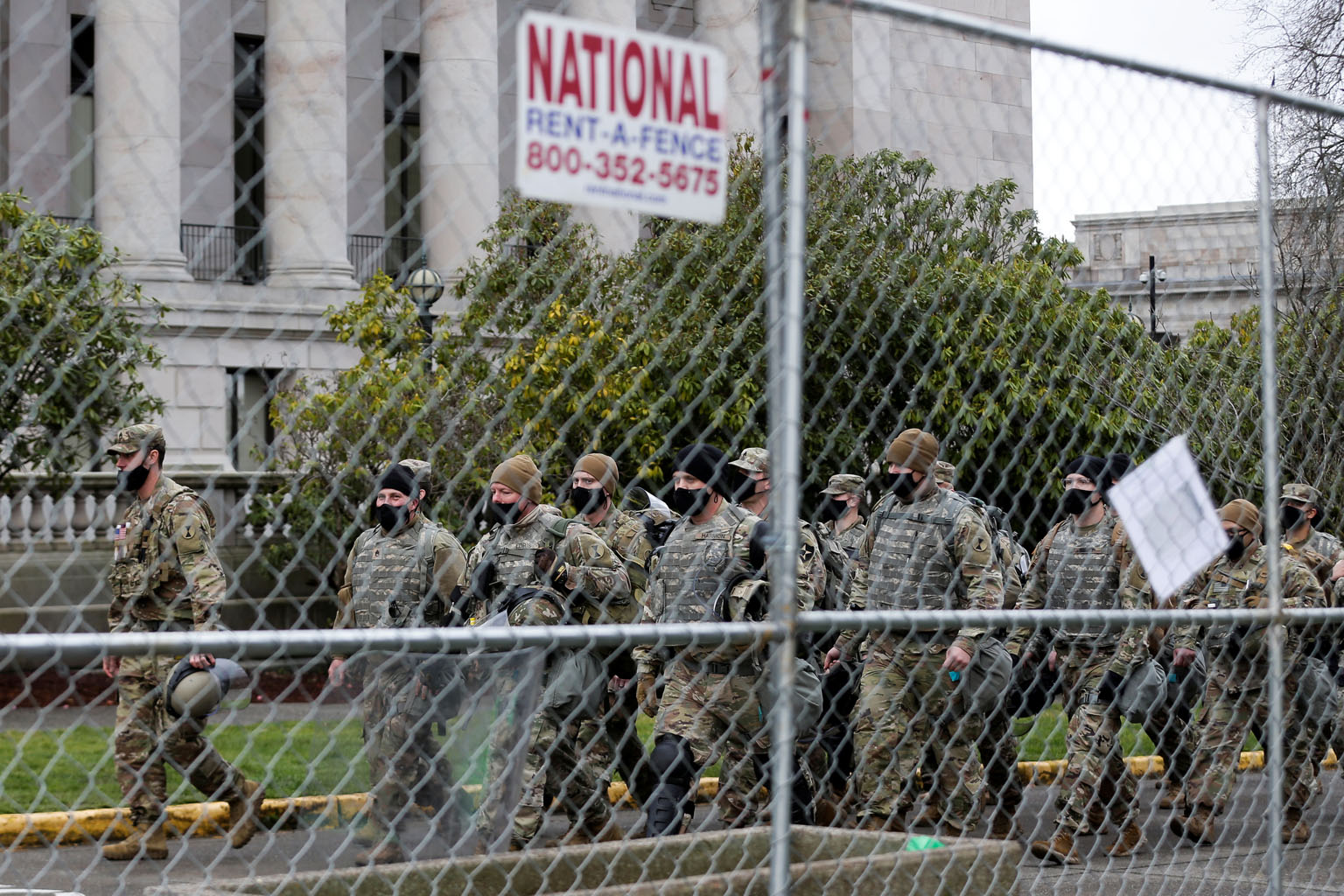 A unit of the Washington National Guard outside the Washington State Capitol in anticipation of potential armed protests in Olympia on Sunday. More than a dozen states activated National Guard troops to help secure their capitol buildings.