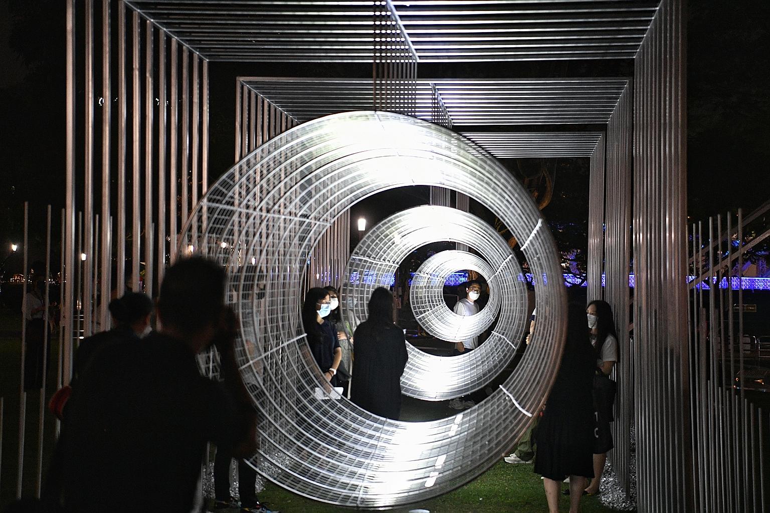 People enjoying a new perspective on things through this giant telescope on the Asian Civilisations Museum Green yesterday. Ways Of Seeing was produced by architecture studio Zarch Collaboratives and is one of the highlights of this year's Light to N