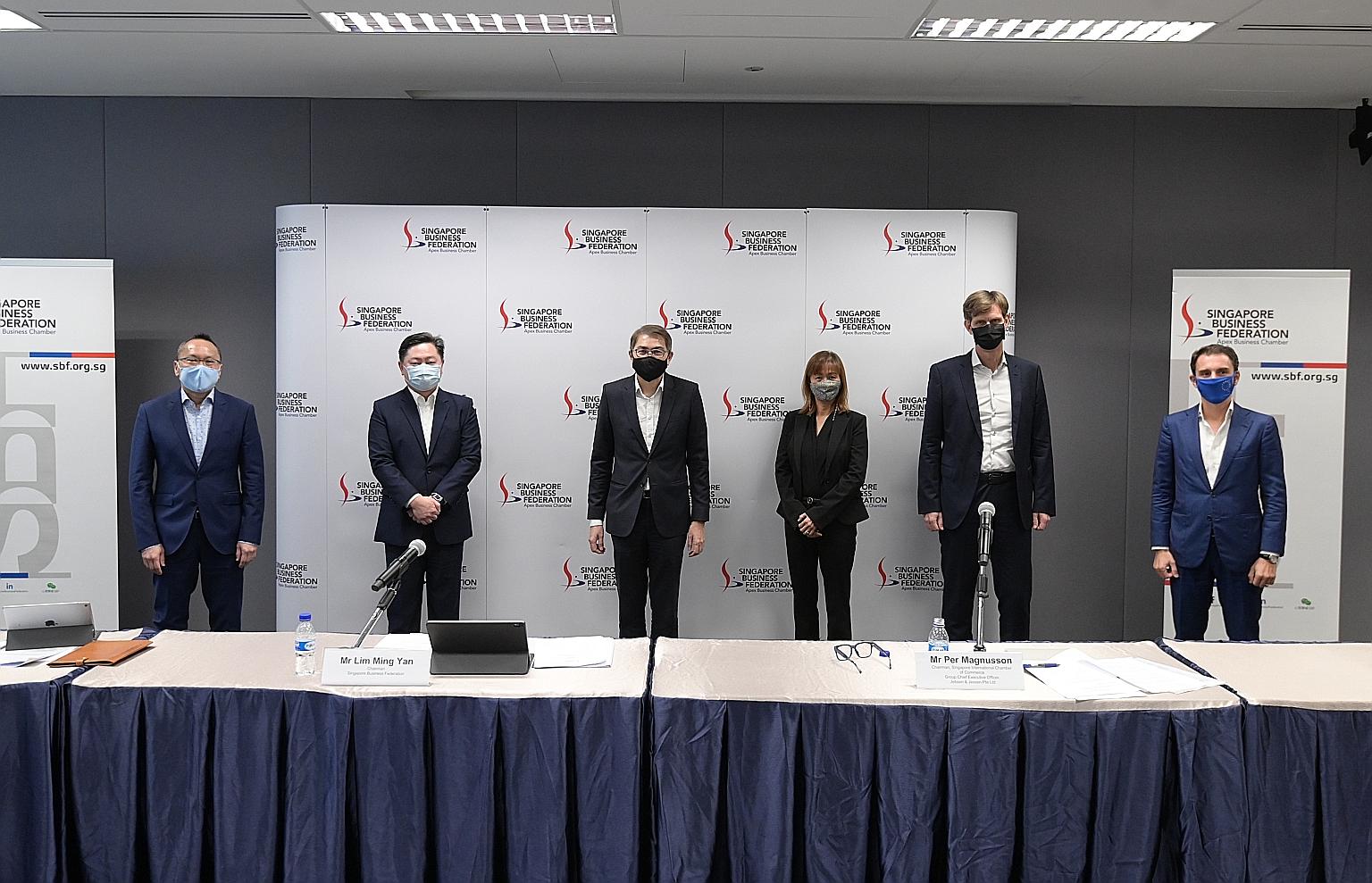 Singapore Business Federation chairman Lim Ming Yan (third from left) at yesterday's media conference at the SBF Centre, joined by (from left) Association of Banks in Singapore vice-chairman John Lee, Restaurant Association of Singapore president And