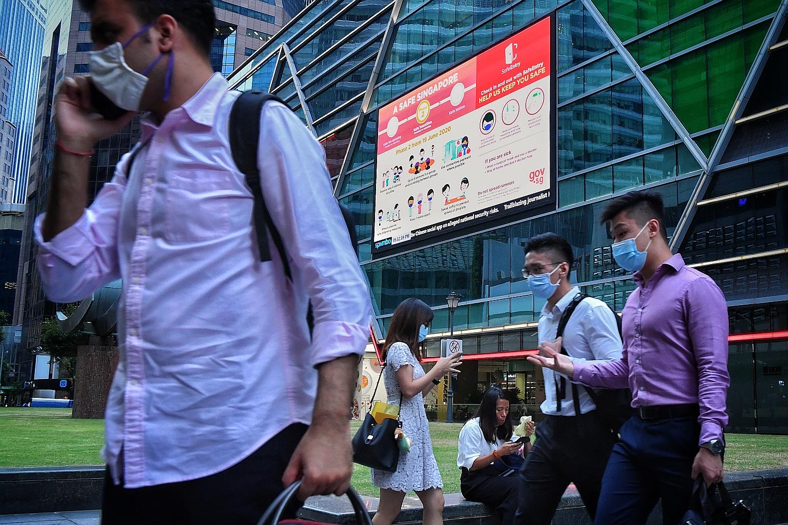 Office workers at Raffles Place. The report said there will be a further drive this year to digitise businesses with tech professionals.