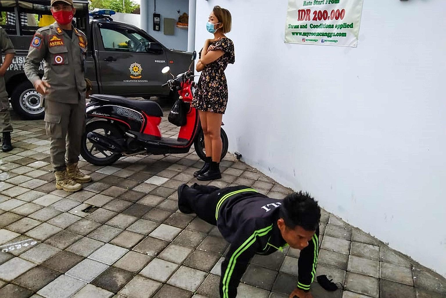 Above: A foreigner in Bali doing squats as punishment for not wearing a face mask or for wearing it improperly. Left: A man doing push-ups for a similar offence. PHOTOS: AGENCE FRANCE-PRESSE