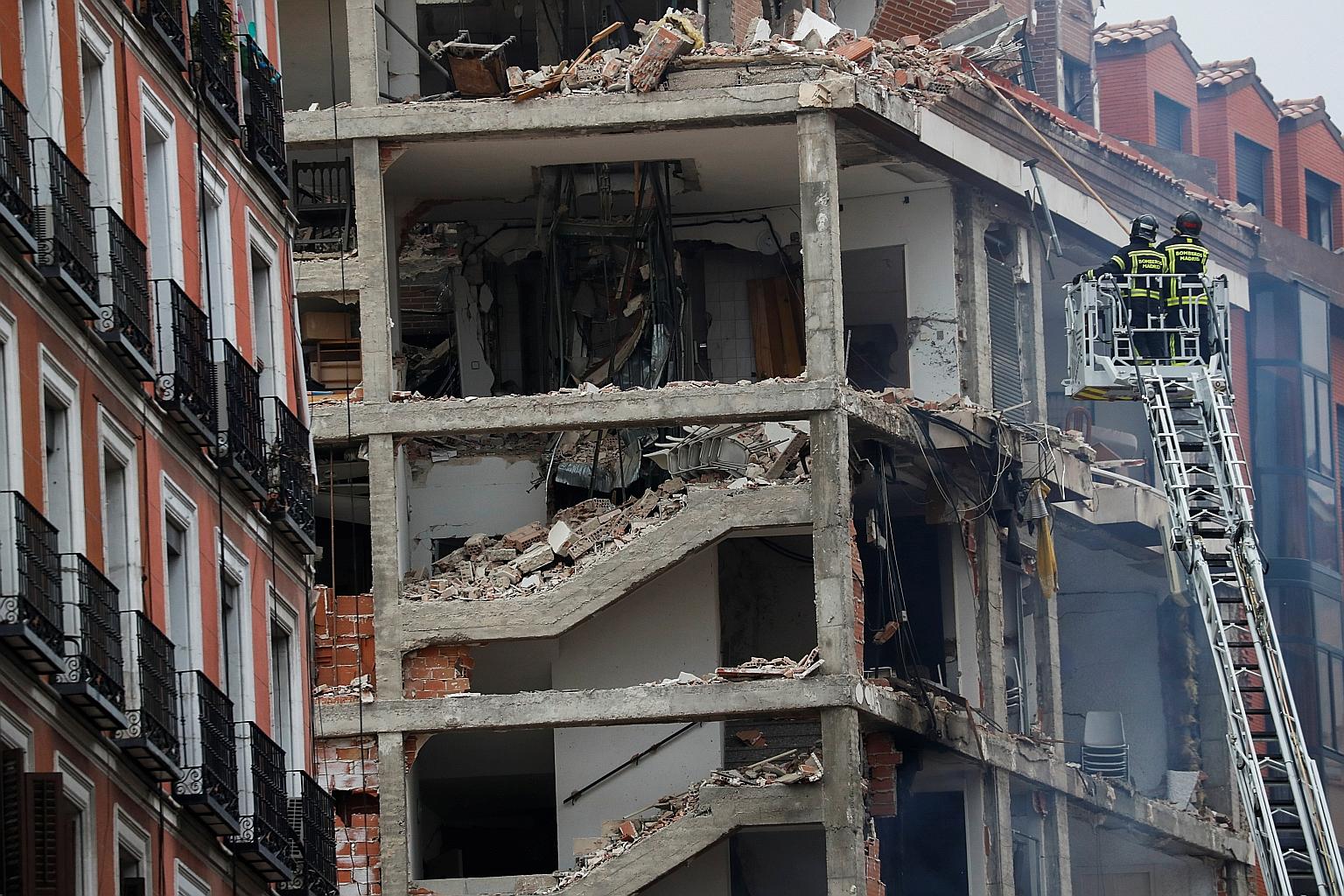 Firefighters on a ladder approaching a damaged building in Madrid after a strong explosion ripped through it. The blast yesterday seemed to have been caused by a gas leak, officials said. PHOTO: REUTERS